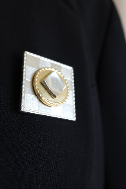 Made in France square brooch — close-up on blazer lapel