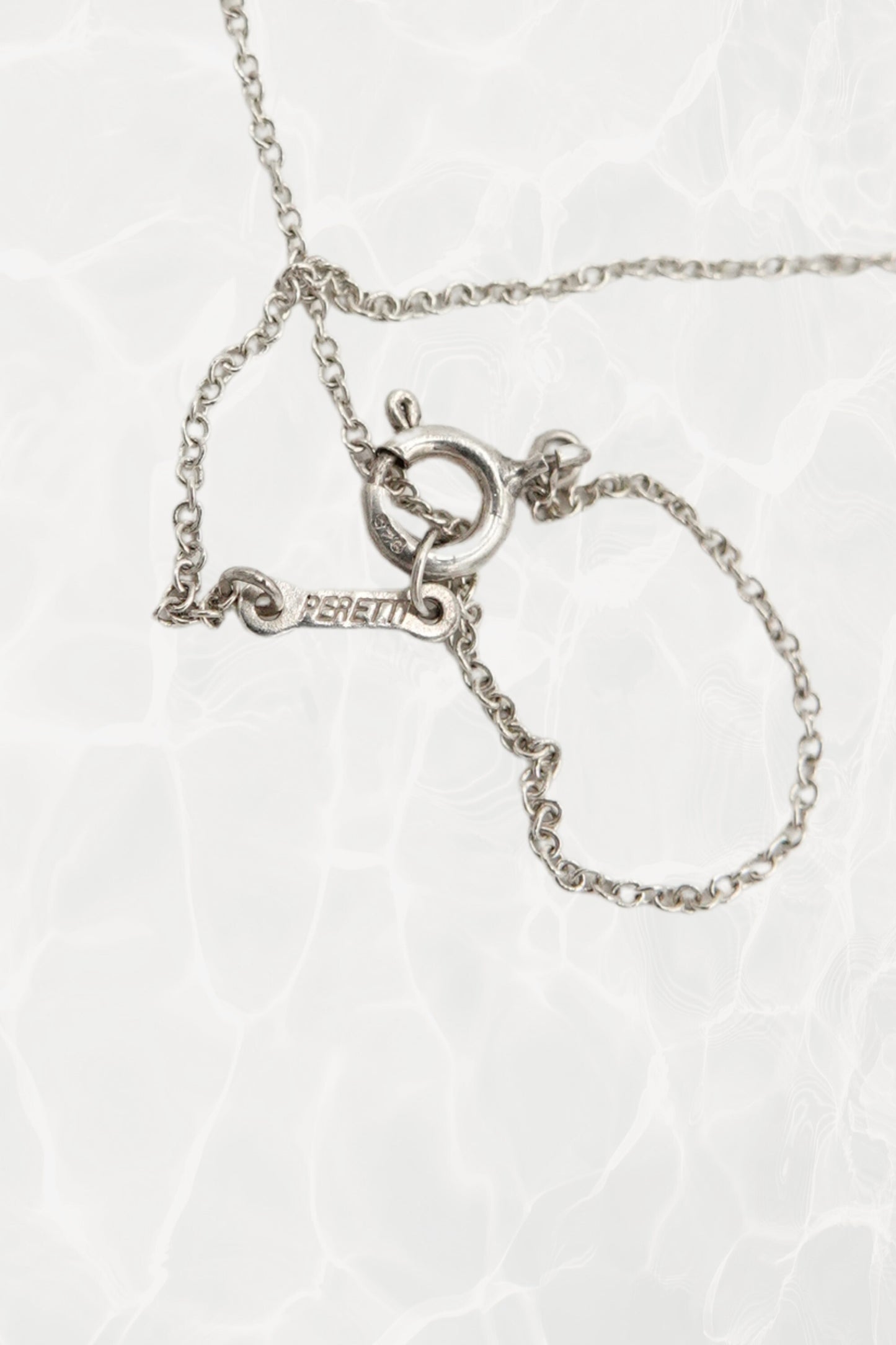 Elsa Peretti for Tiffany & Co. sterling silver Madonna pendant necklace: reverse side view of pendant showing smooth back finish and sterling silver hallmark detail