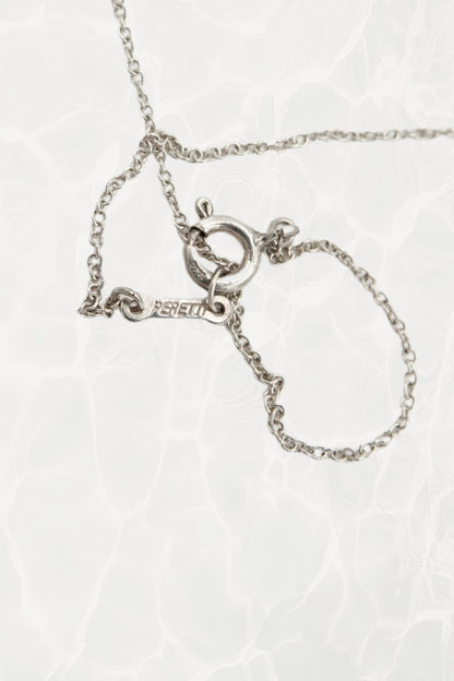 Elsa Peretti for Tiffany & Co. sterling silver Madonna pendant necklace: reverse side view of pendant showing smooth back finish and sterling silver hallmark detail