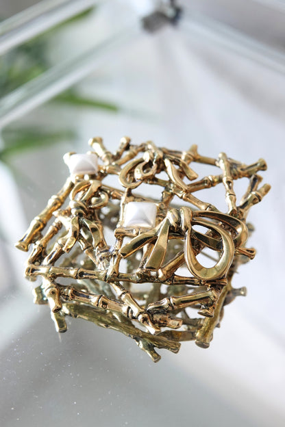 Gold bamboo brooch — side angle showing lattice depth