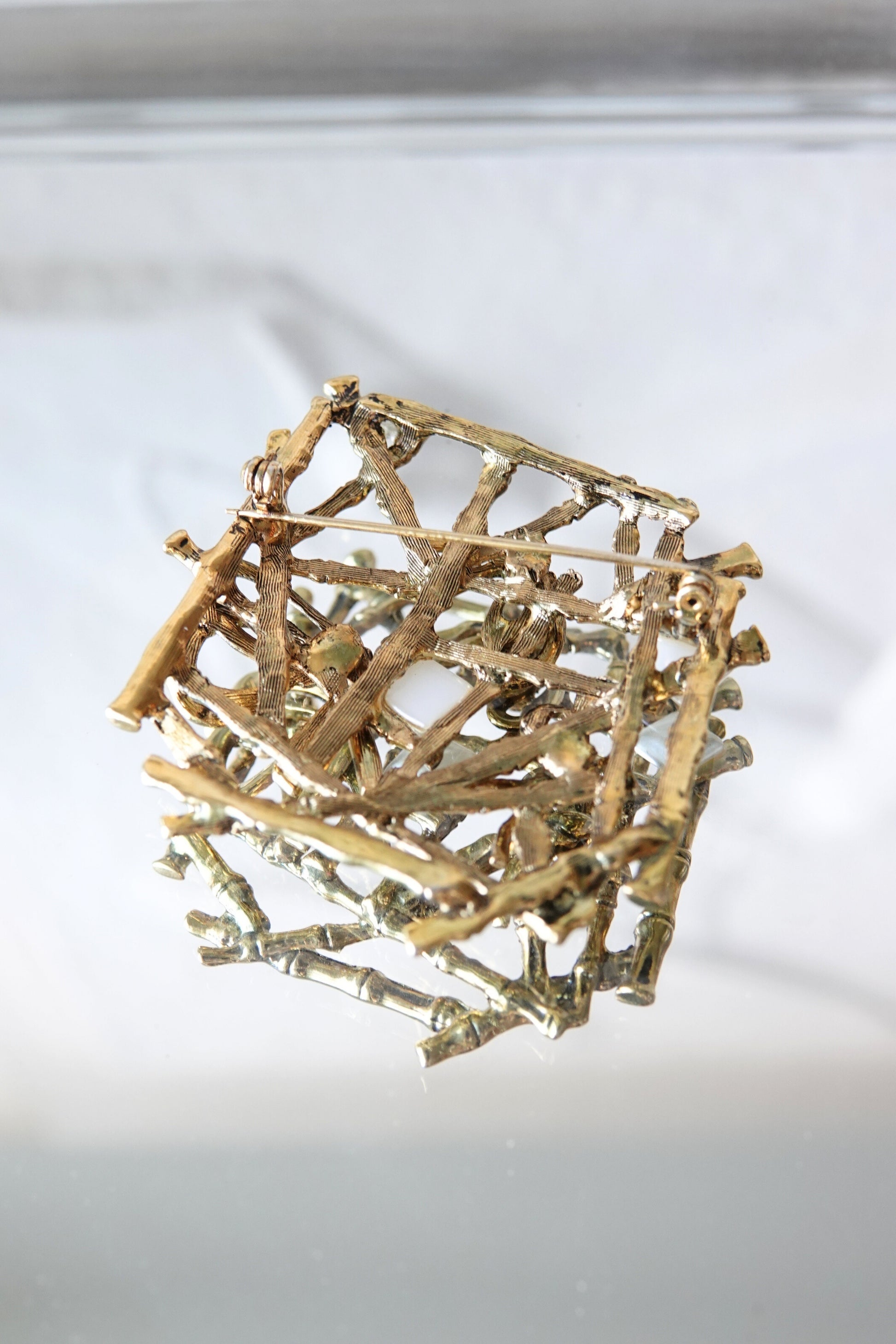 Bamboo lattice brooch — close-up of gold-tone segments and pearl accents