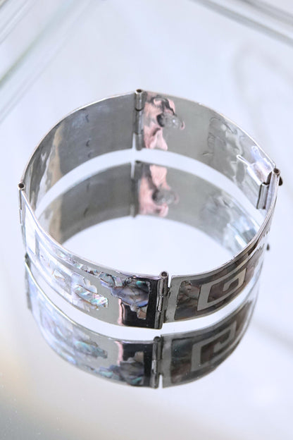 Mexican sterling silver abalone cuff bracelet styled on glass, side angle