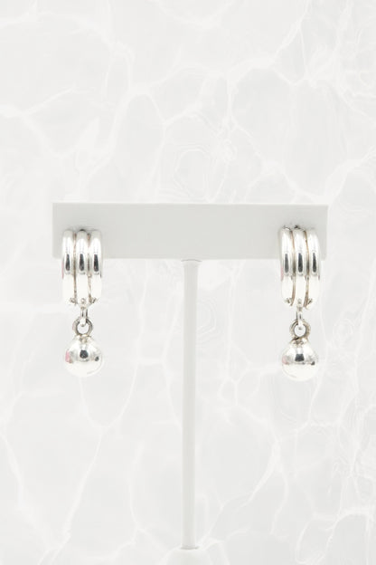 Sterling silver Mexican earrings — pair on earring stand, front view