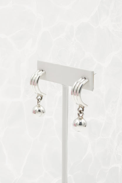 Sterling silver crescent earrings — close-up of ribbed top and ball dangle