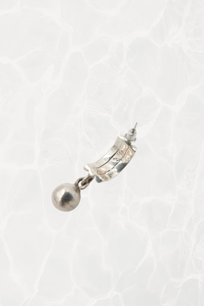 Mexican silver earrings — three-quarter view on stand