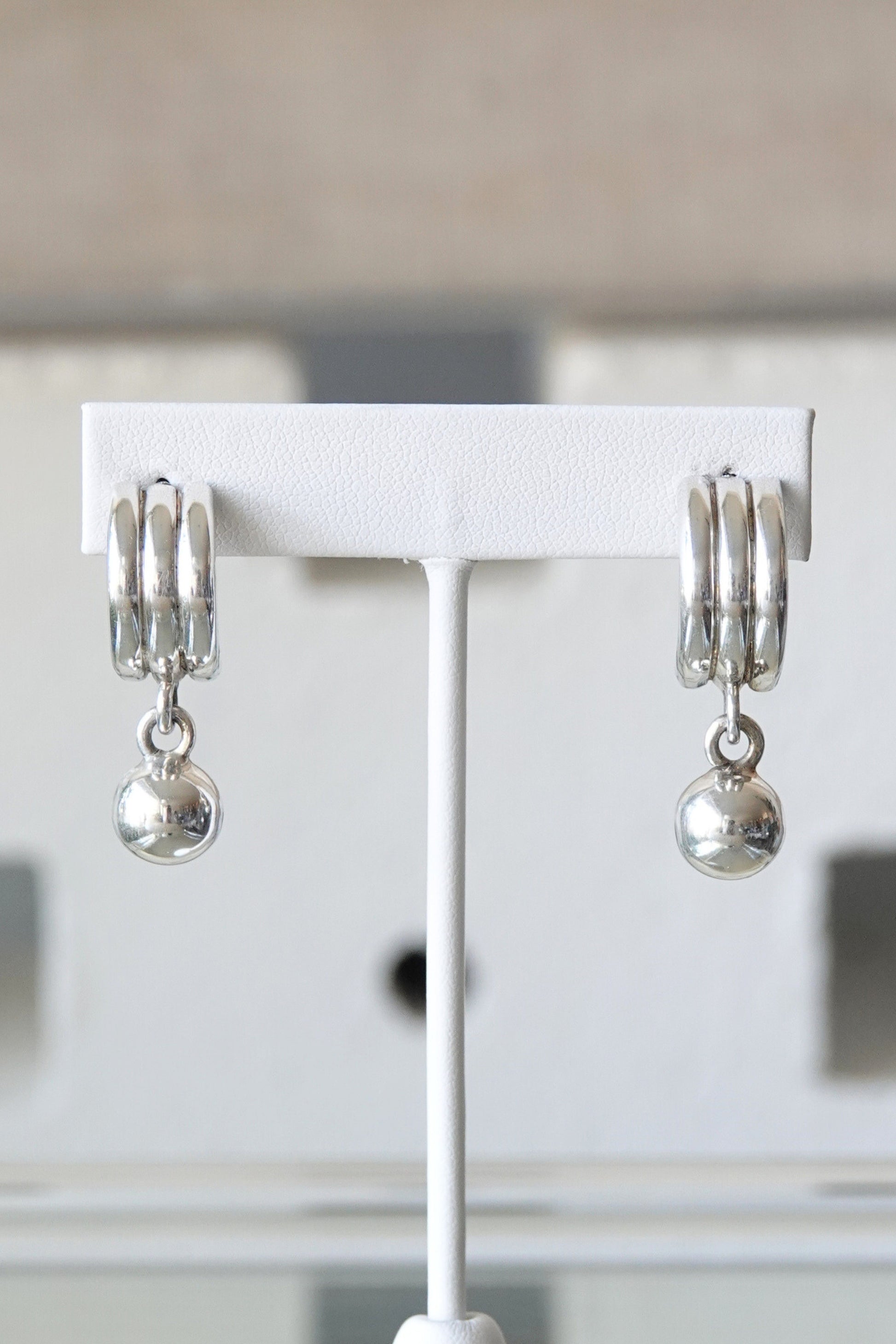 925 Mexico silver earrings — pair on glass reflective surface