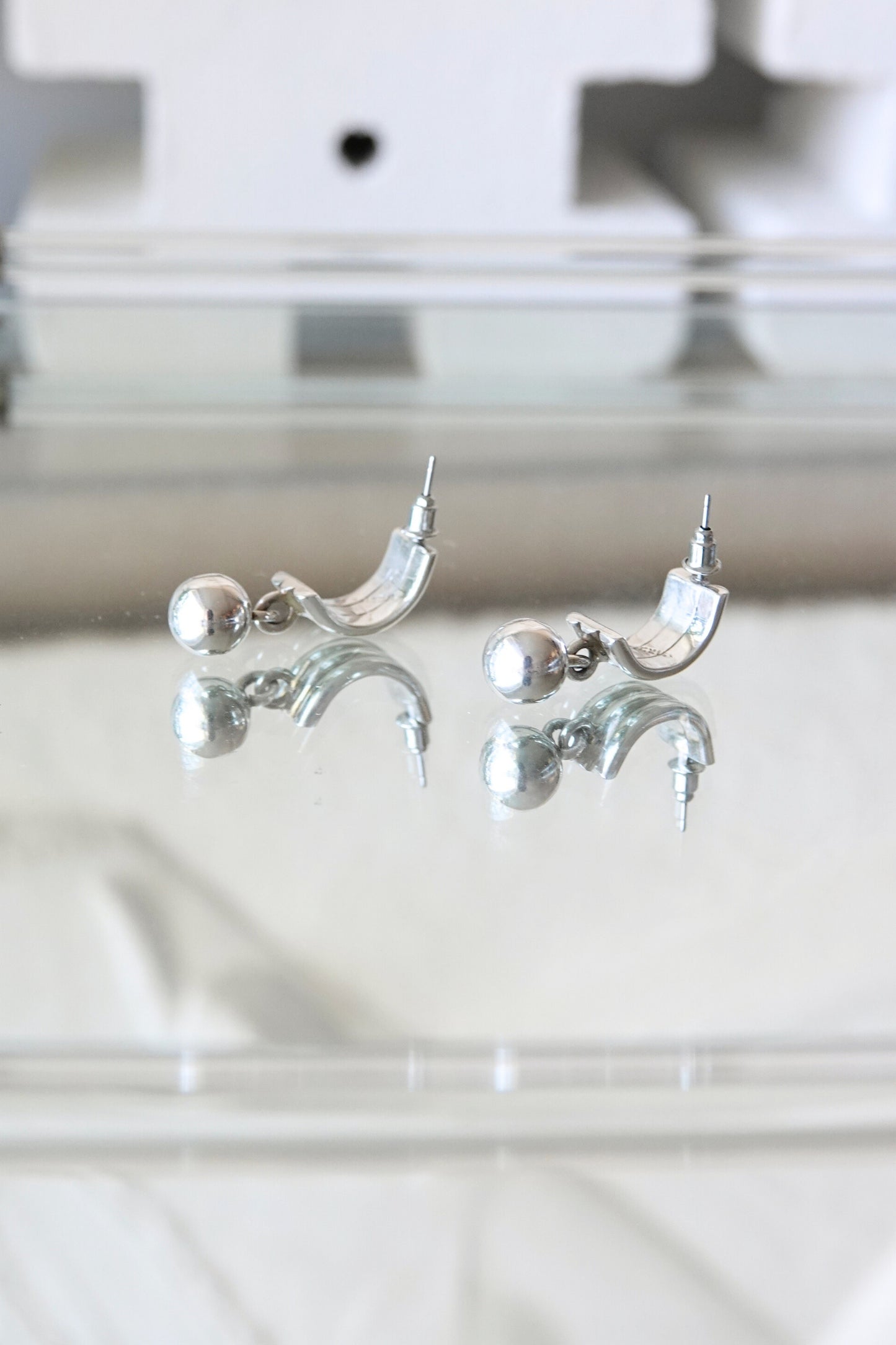 Sterling silver ball dangle earrings — close-up detail on glass