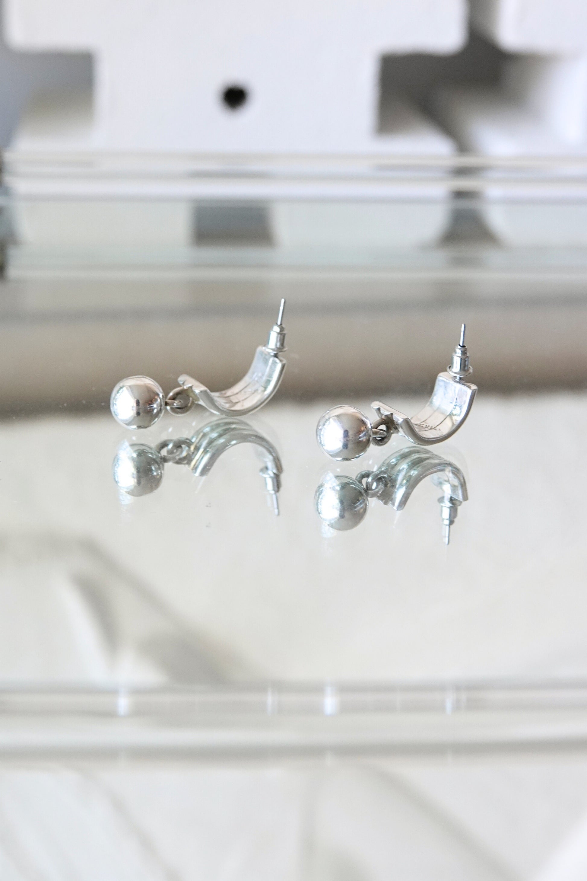 Sterling silver ball dangle earrings — close-up detail on glass