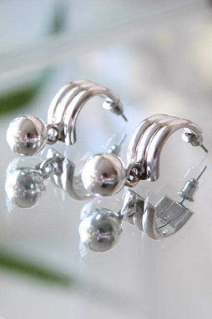 Mexican 925 silver earrings — angled view on glass