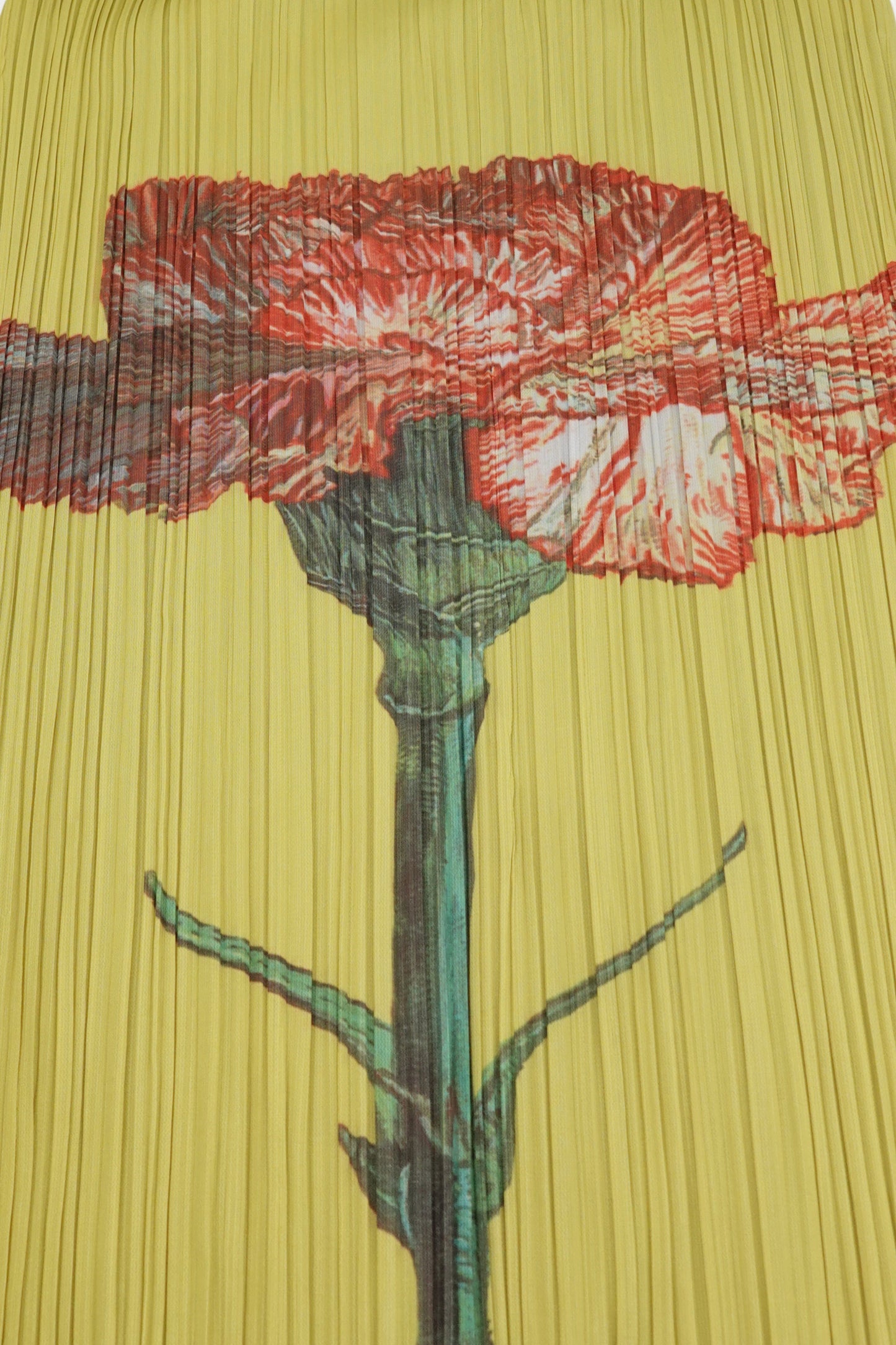 Pleats Please Issey Miyake x Mimi Yokoo carnation print dress detail: close-up of engineered red carnation botanical print with green stem on yellow pleated fabric, Mimi Yokoo artist collaboration, c. 2000