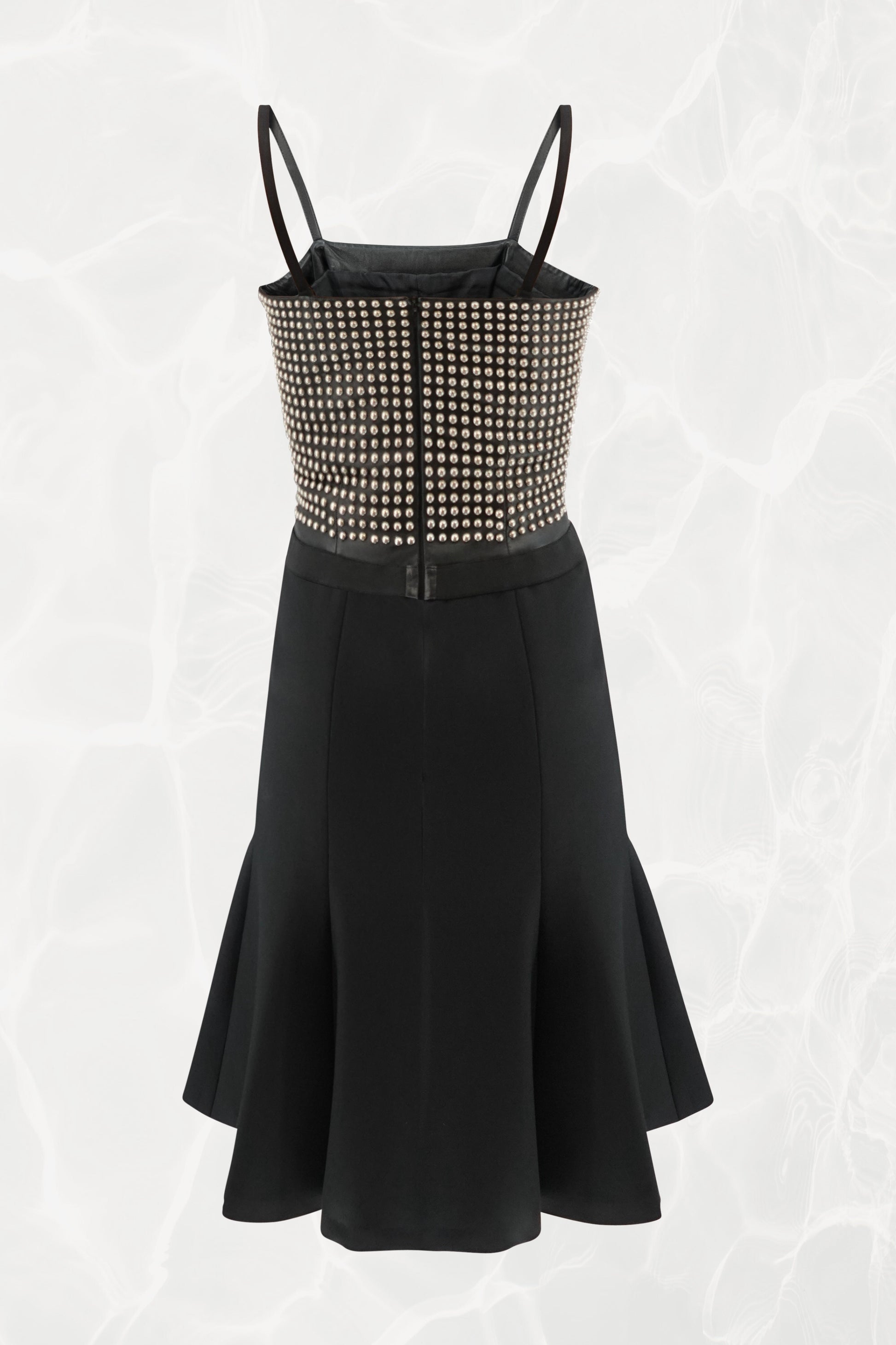 Loewe by Narciso Rodriguez AW01 studded leather dress side view: profile of fitted metal-studded leather corset bodice with elastic shoulder strap and paneled black silk flare skirt, AW2001