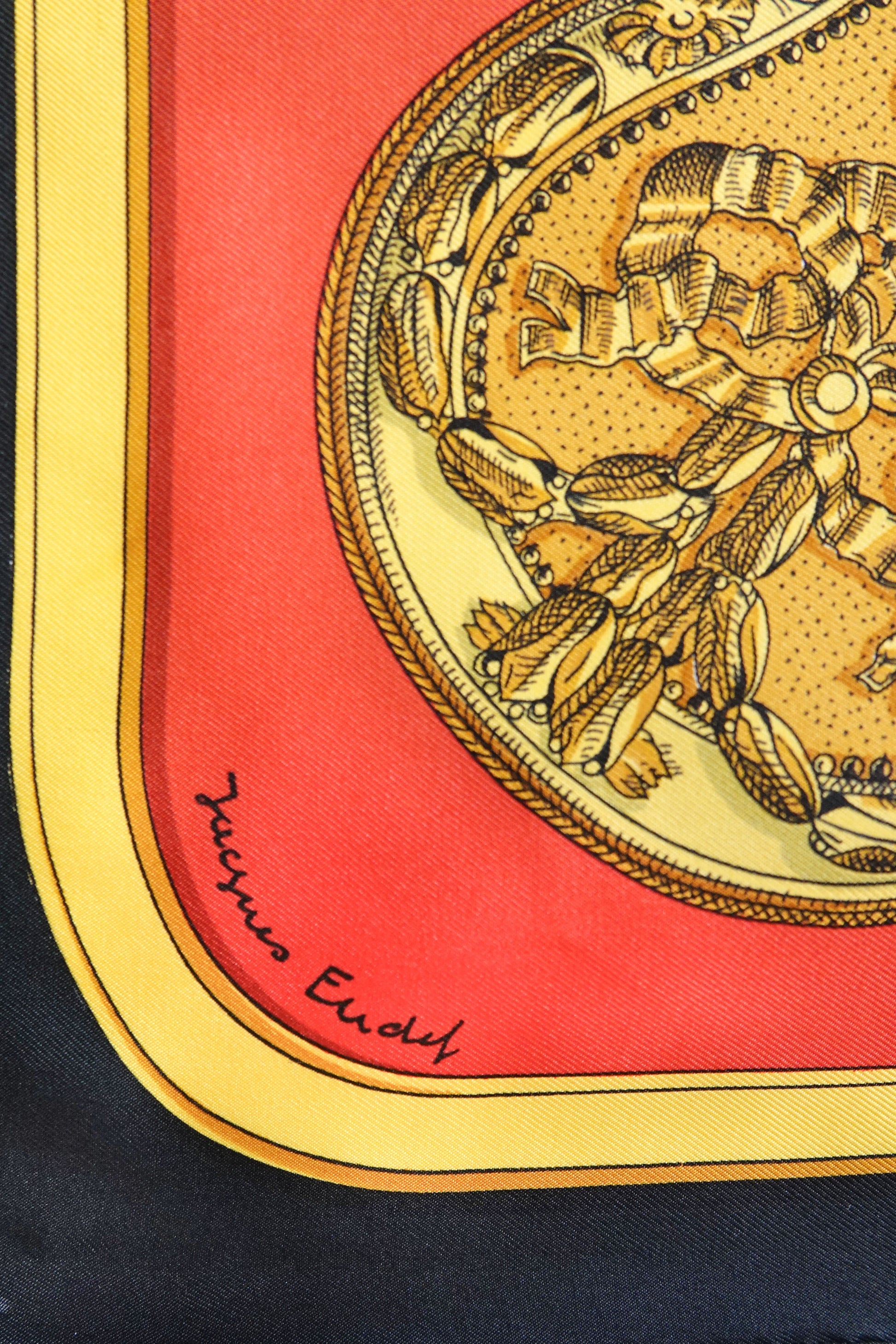 Hermès Grand Apparat Carré 90 designer signature: Jacques Endy, gold medallion corner detail on red and yellow silk