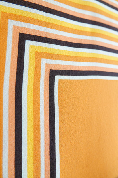 1970s YSL Yves Saint Laurent silk scarf: draped view showing the fluidity and drape of the silk fabric with the concentric square stripe print in brown and orange