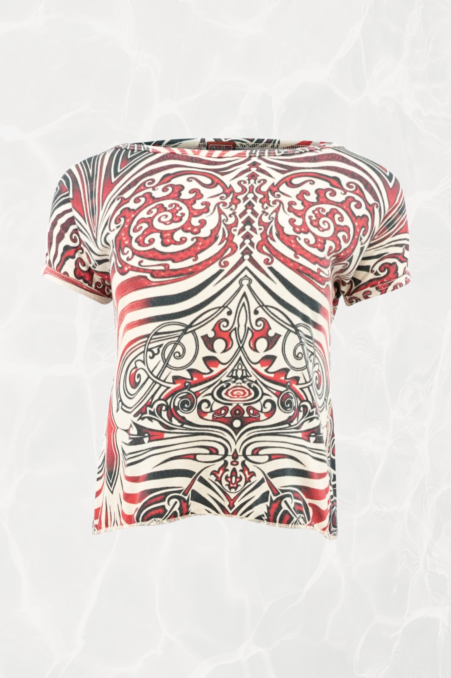 Jean Paul Gaultier JPG Jeans SS96 Cyberbaba crop top front view: short-sleeve jersey knit with tribal tattoo print in red, black and white, open-back design