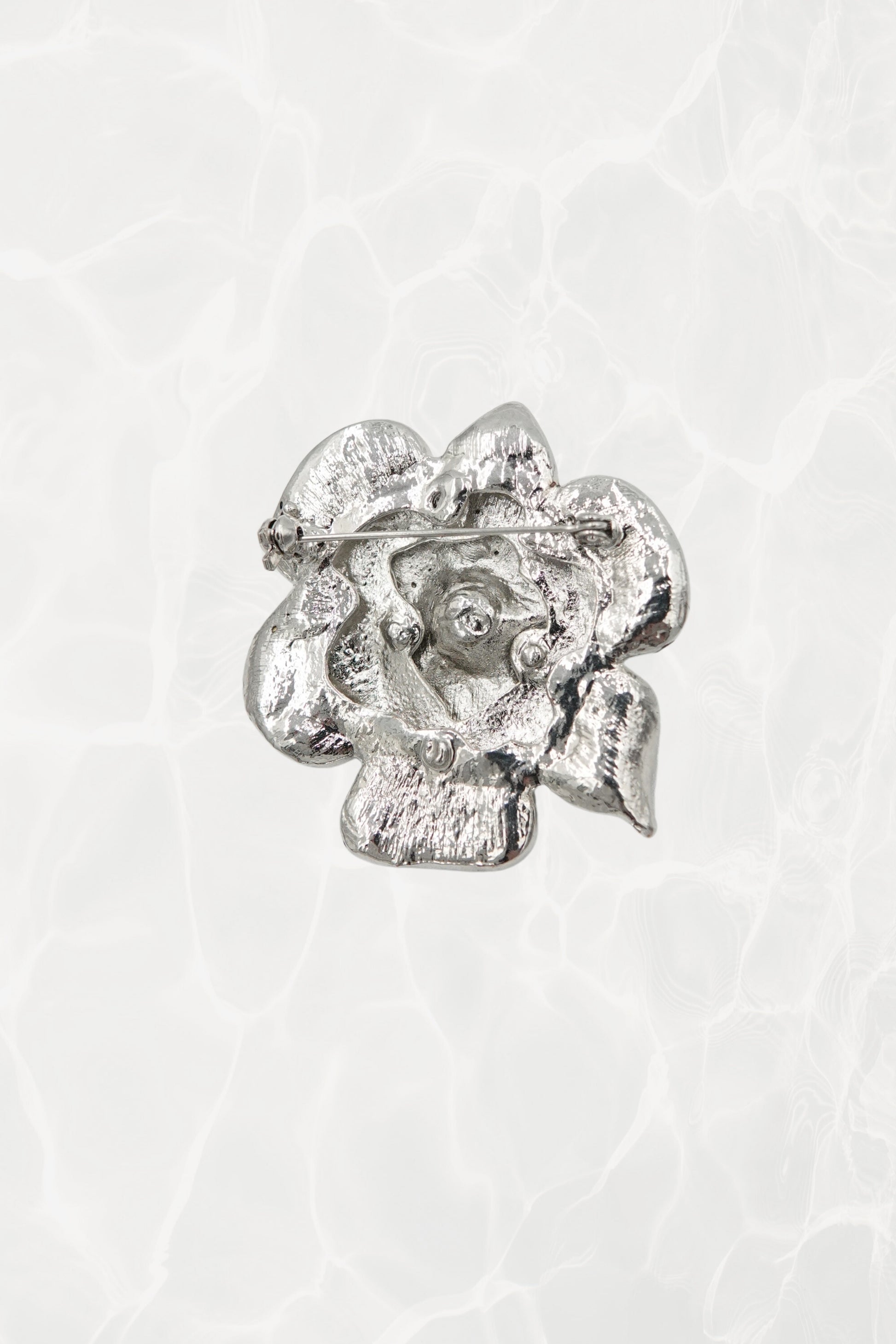 Rhinestone flower brooch — back view showing pin mechanism