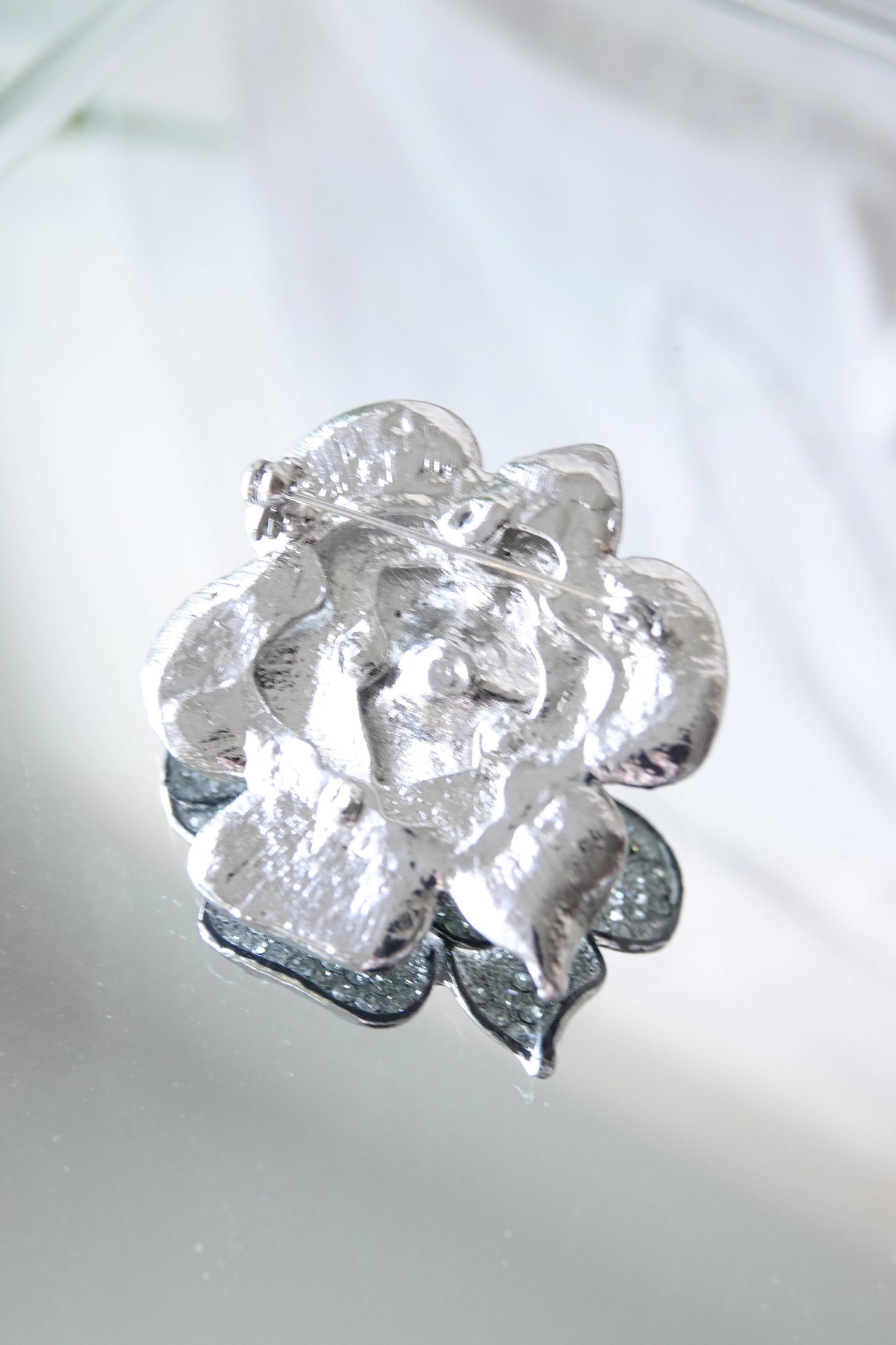 Camellia brooch — back detail on glass surface