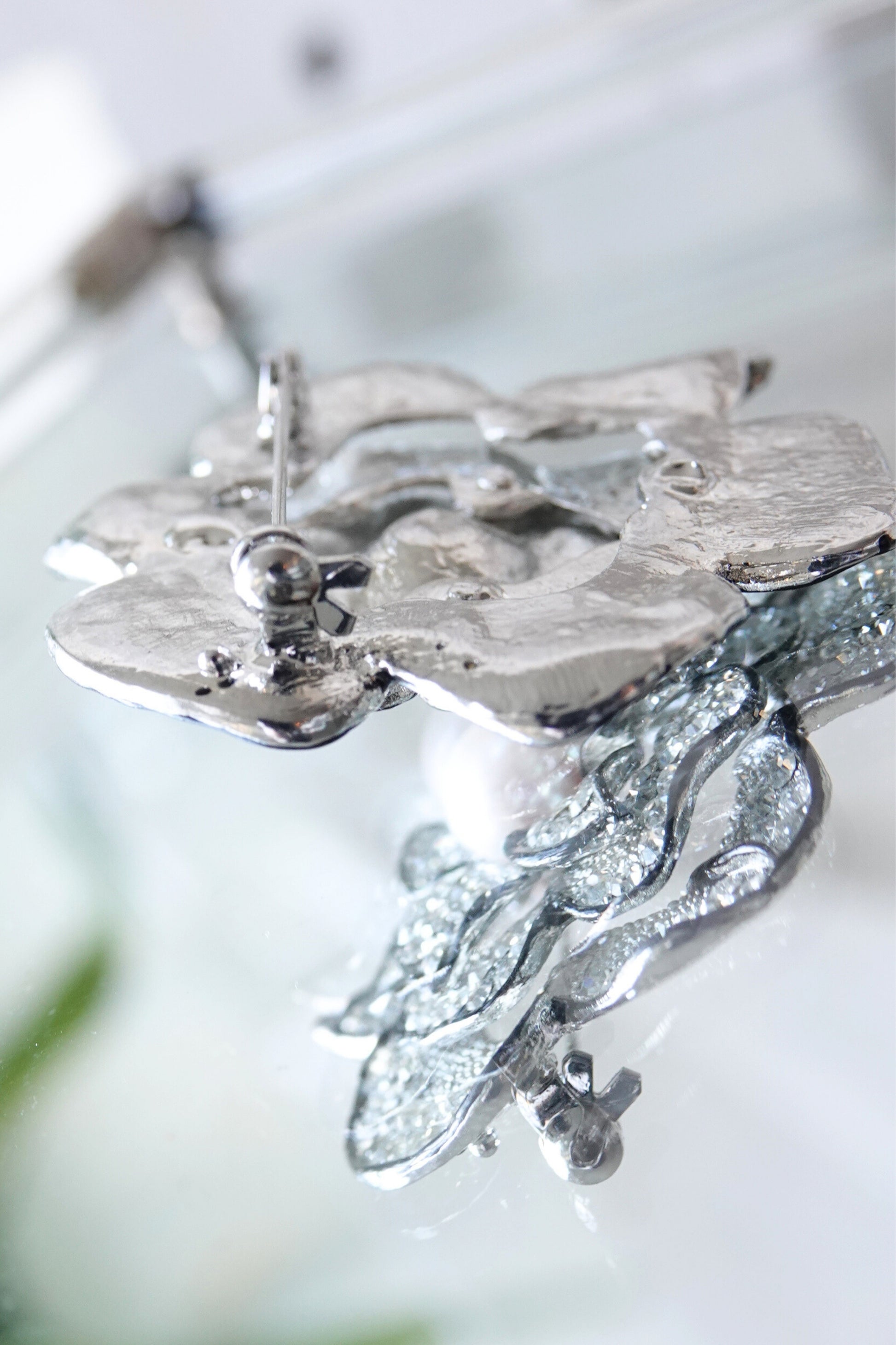 Pavé rhinestone brooch — angled view showing petal depth on glass