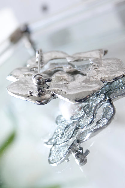 Pavé rhinestone brooch — angled view showing petal depth on glass