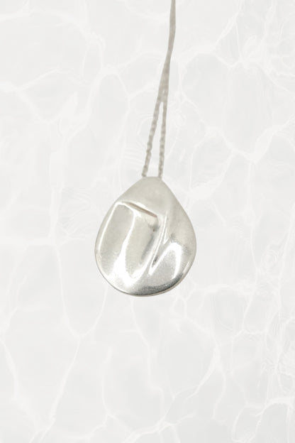 Elsa Peretti for Tiffany & Co. sterling silver Madonna pendant necklace: full front view showing the delicate chain with sculpted Madonna silhouette pendant against neutral background