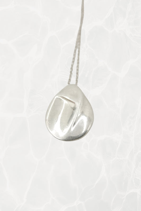 Elsa Peretti for Tiffany & Co. sterling silver Madonna pendant necklace: full front view showing the delicate chain with sculpted Madonna silhouette pendant against neutral background