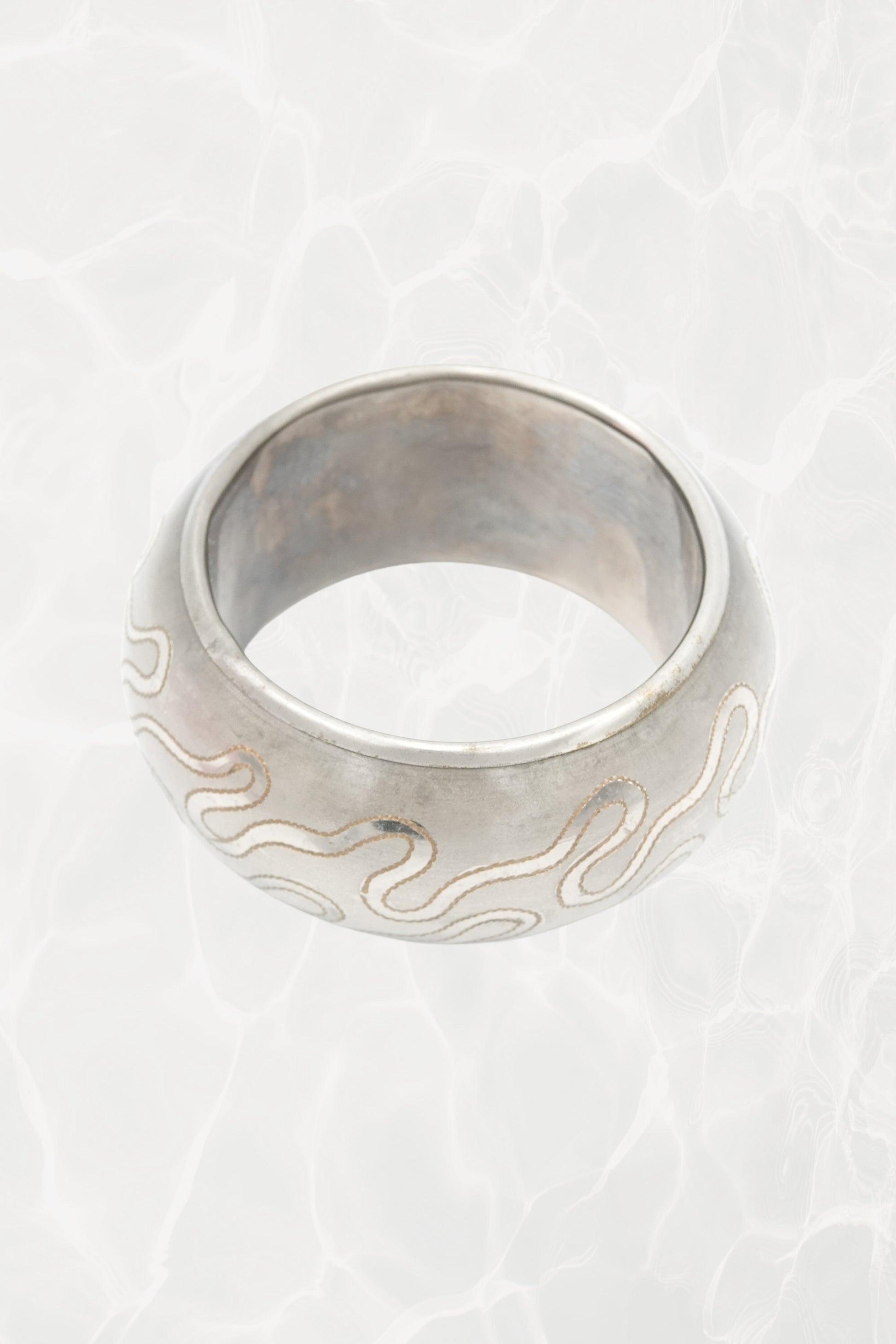 Indian etched white metal bangle — side angle showing snake motif
