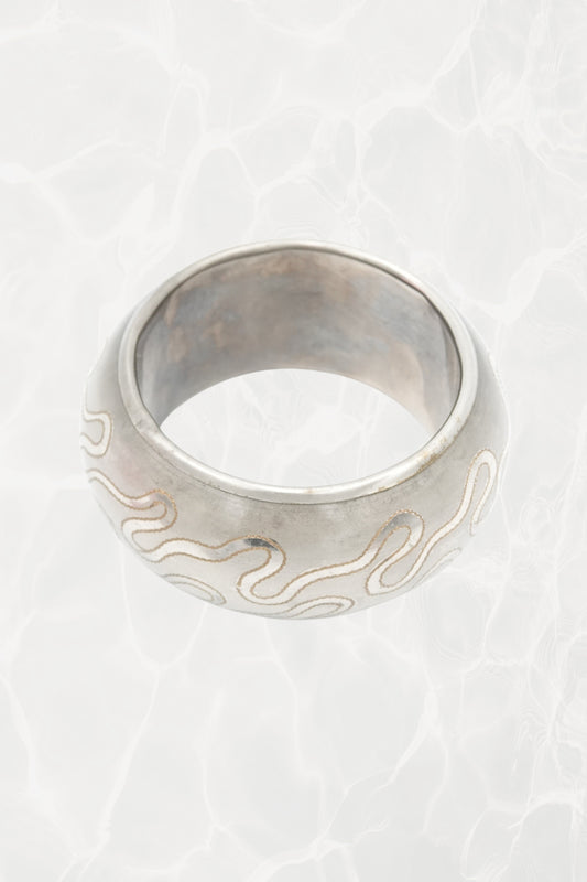 Indian etched white metal bangle — side angle showing snake motif