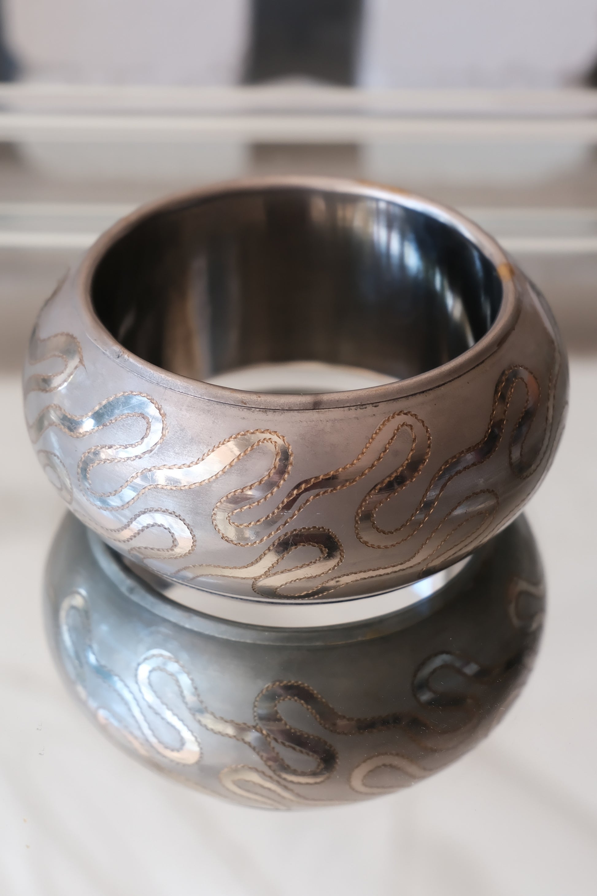 Vintage etched serpentine bangle, India — full side view on reflective marble — Disco Palma