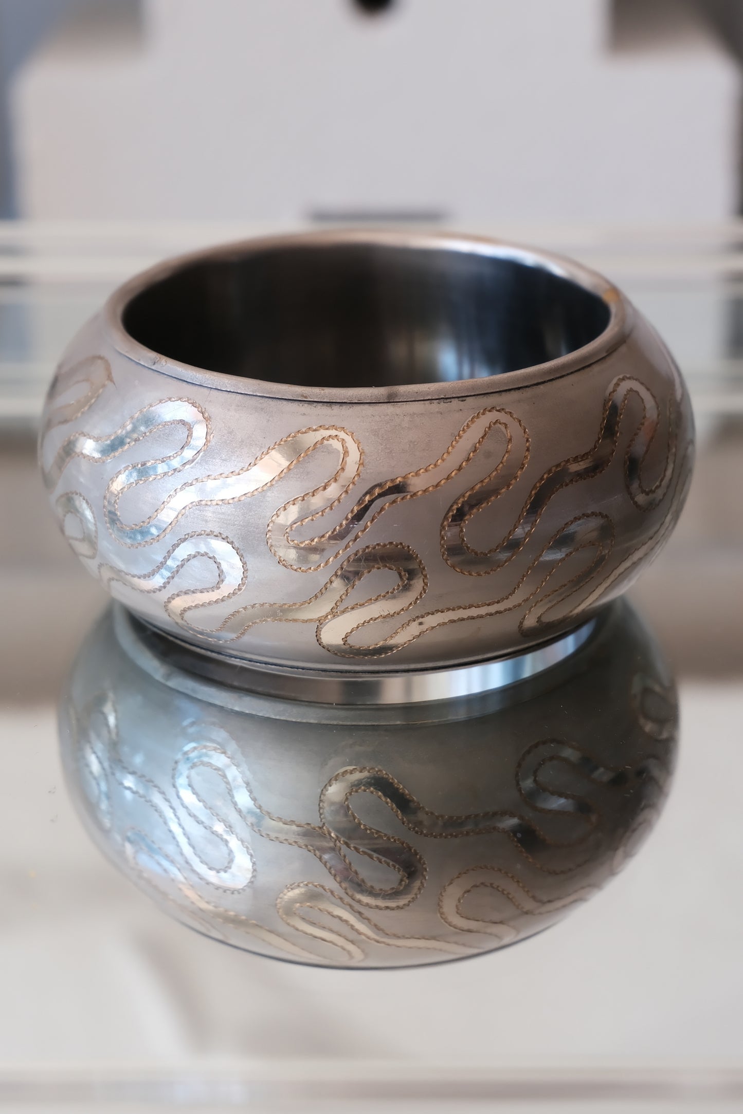 Vintage etched serpentine bangle, top-down view showing dark interior — Disco Palma