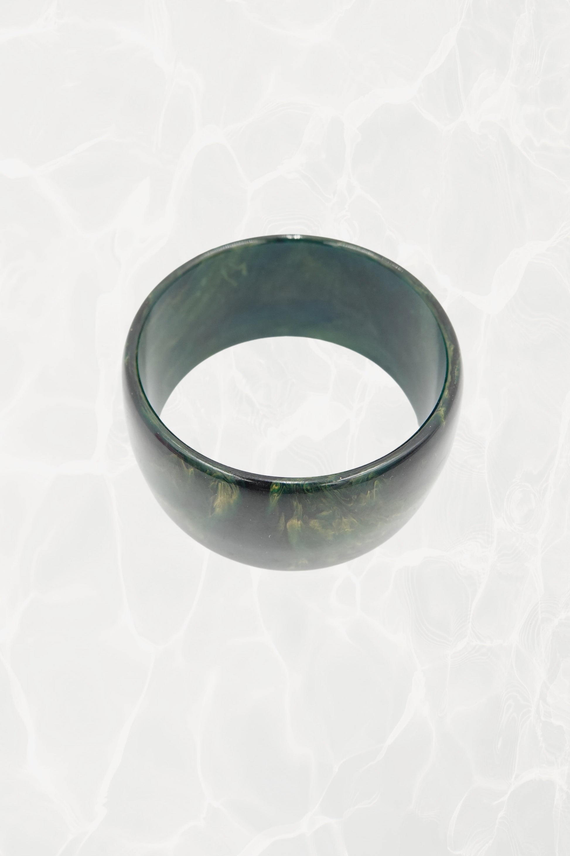 Wide green marbled resin bangle — side angle