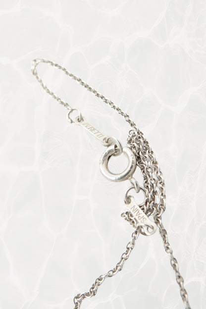 Elsa Peretti for Tiffany & Co. sterling silver starfish necklace hallmark detail: close-up of Tiffany & Co. and Elsa Peretti sterling silver 925 hallmark engraving on pendant reverse