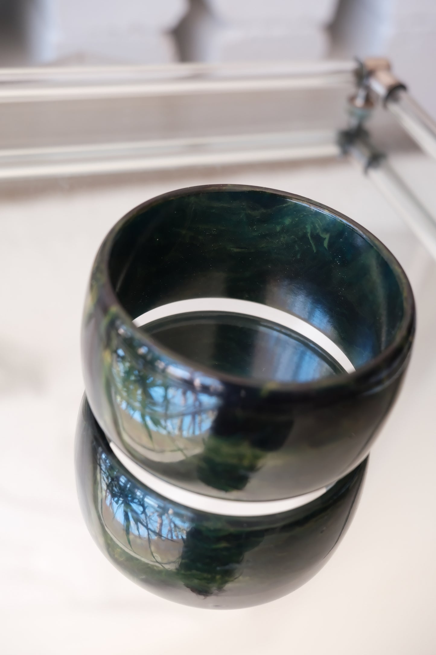 Deep green marbled bangle — top-down styled view