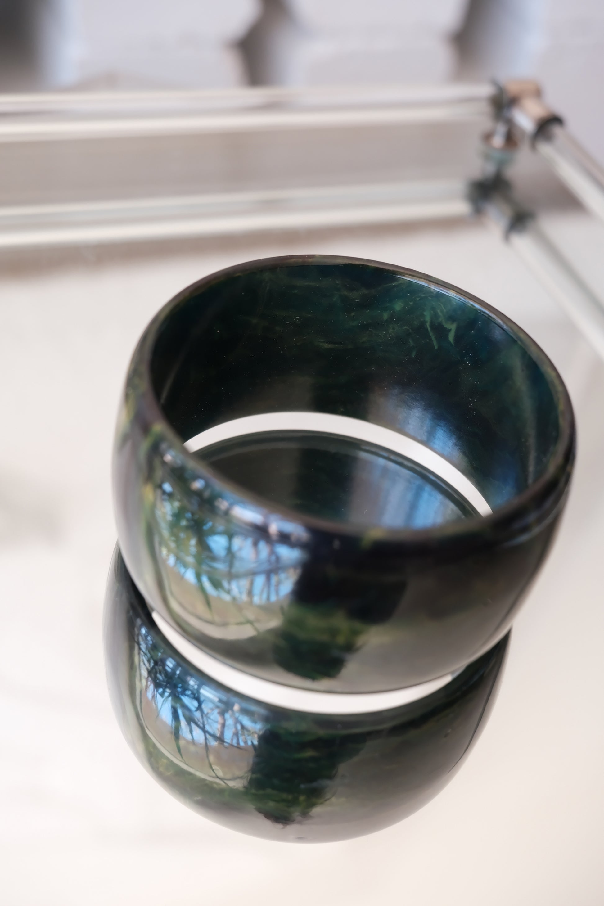 Deep green marbled bangle — top-down styled view
