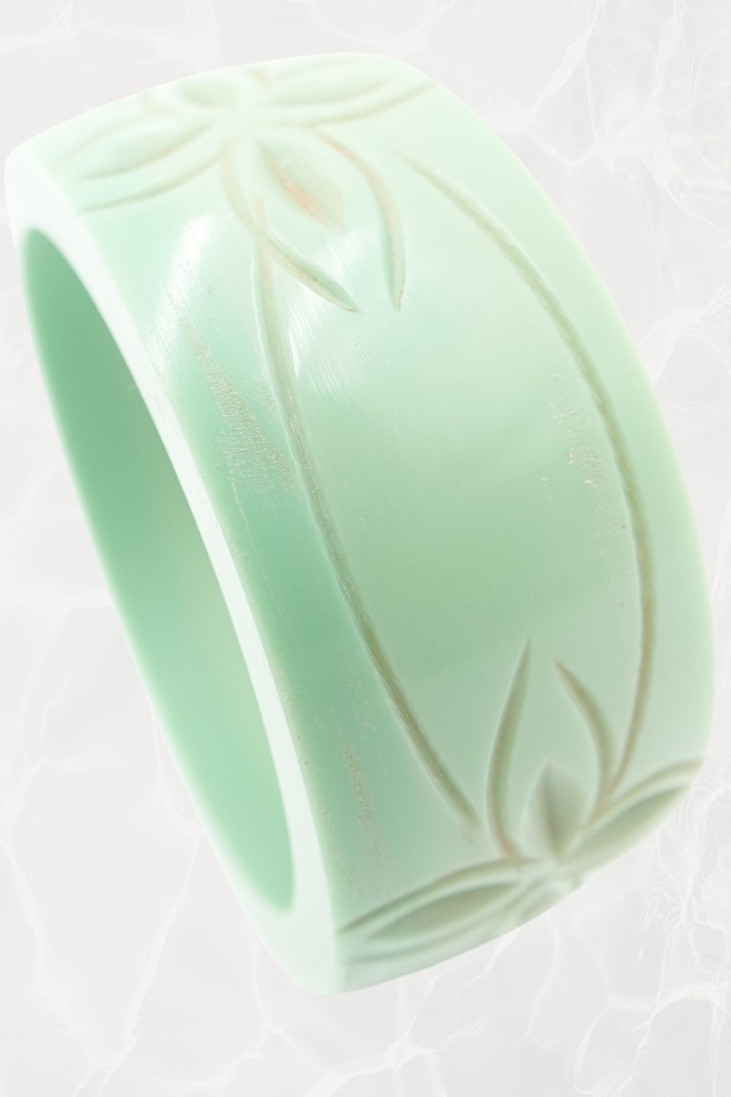 Carved celadon Bakelite bangle — top-down view