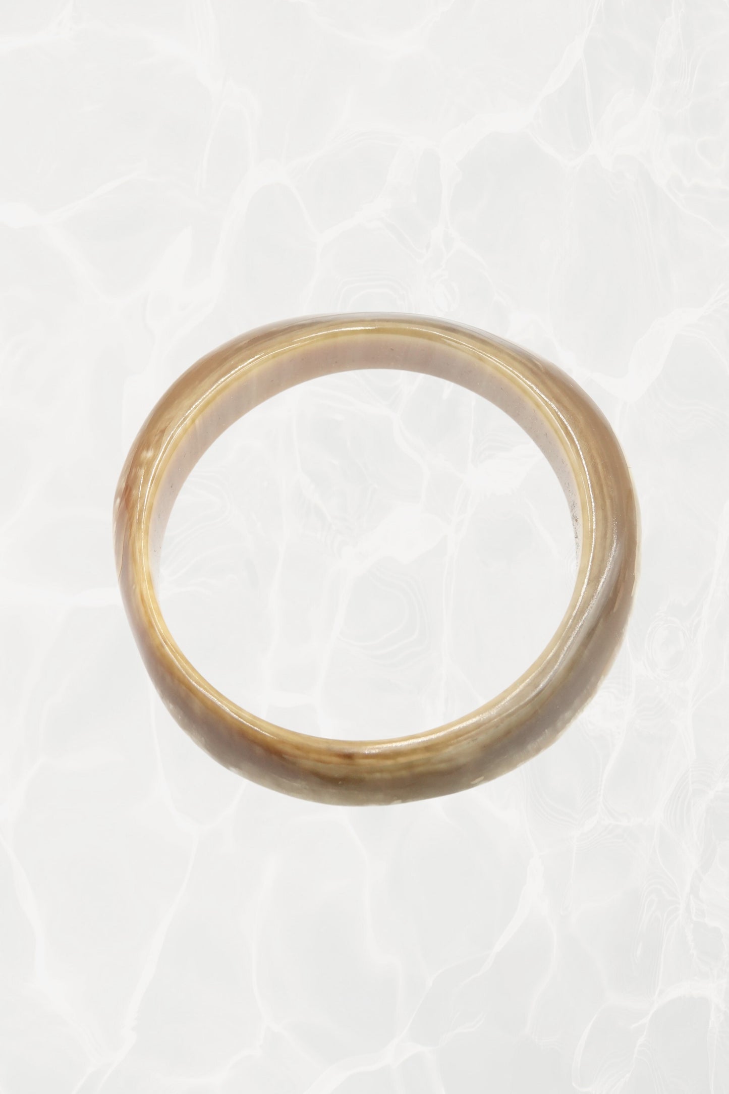 Natural horn bangle — top-down view showing organic figuring