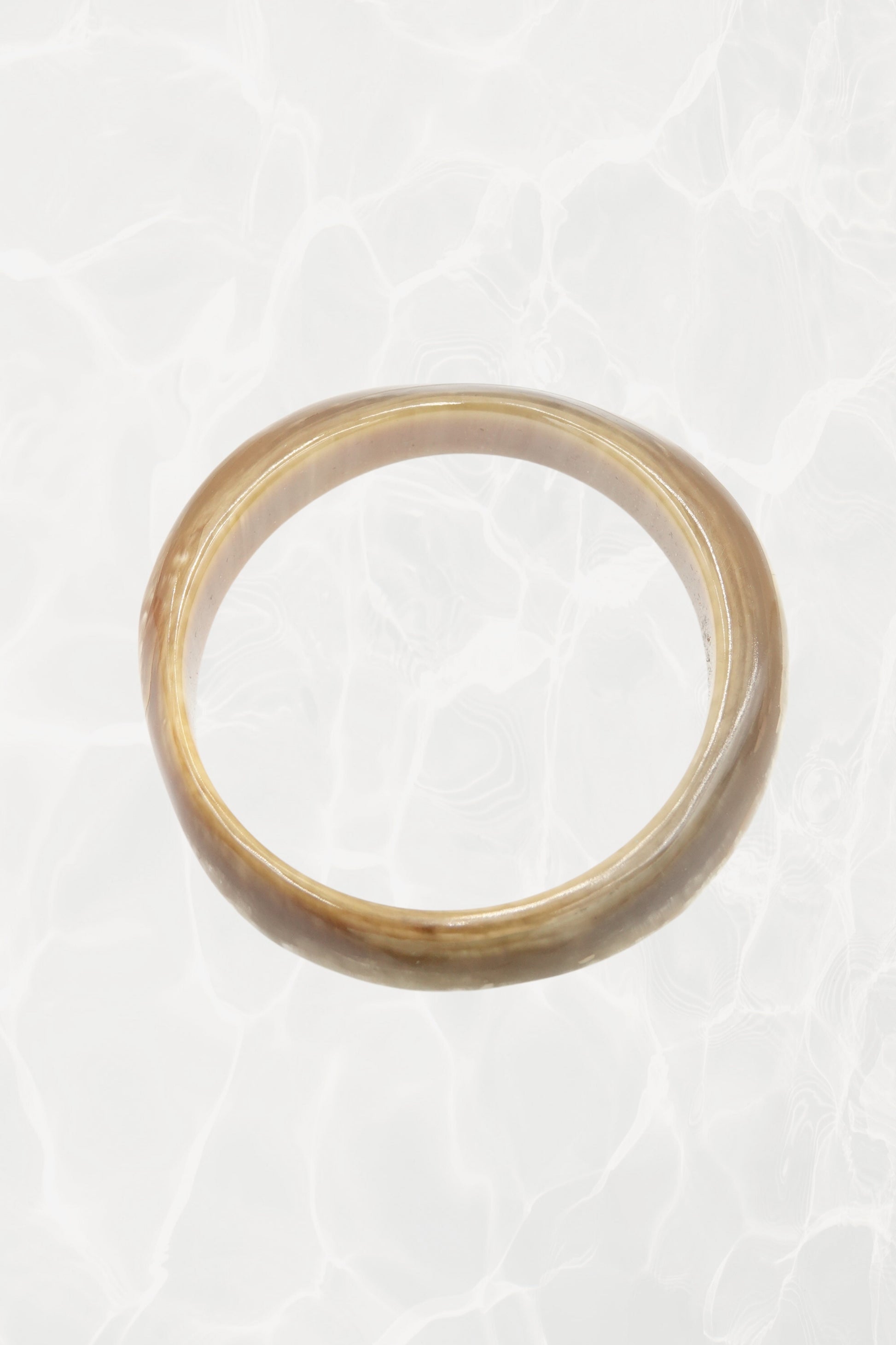 Natural horn bangle — top-down view showing organic figuring