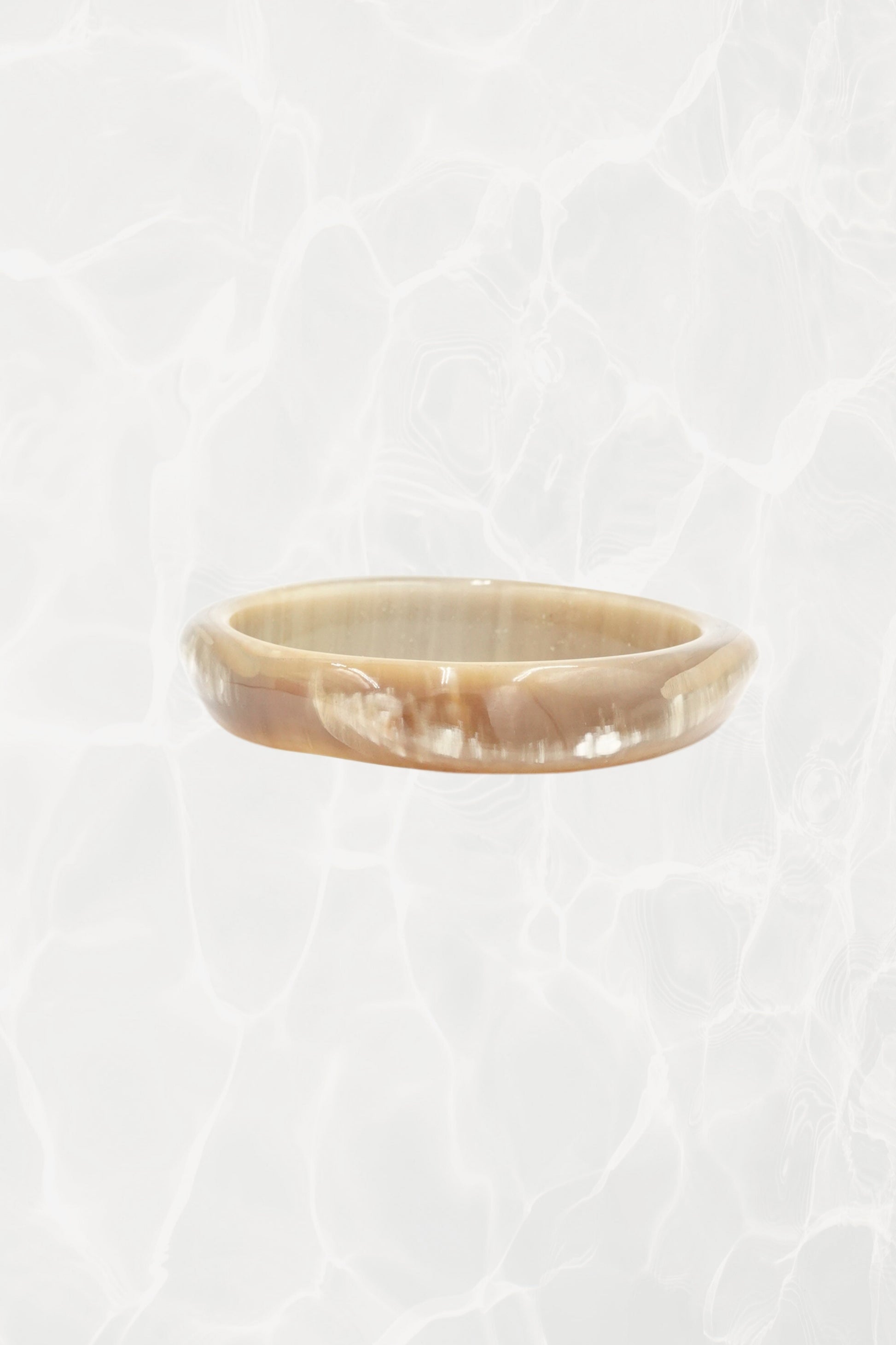 Natural horn bangle — close-up showing caramel and cream tones