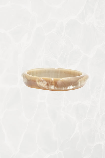 Natural horn bangle — close-up showing caramel and cream tones