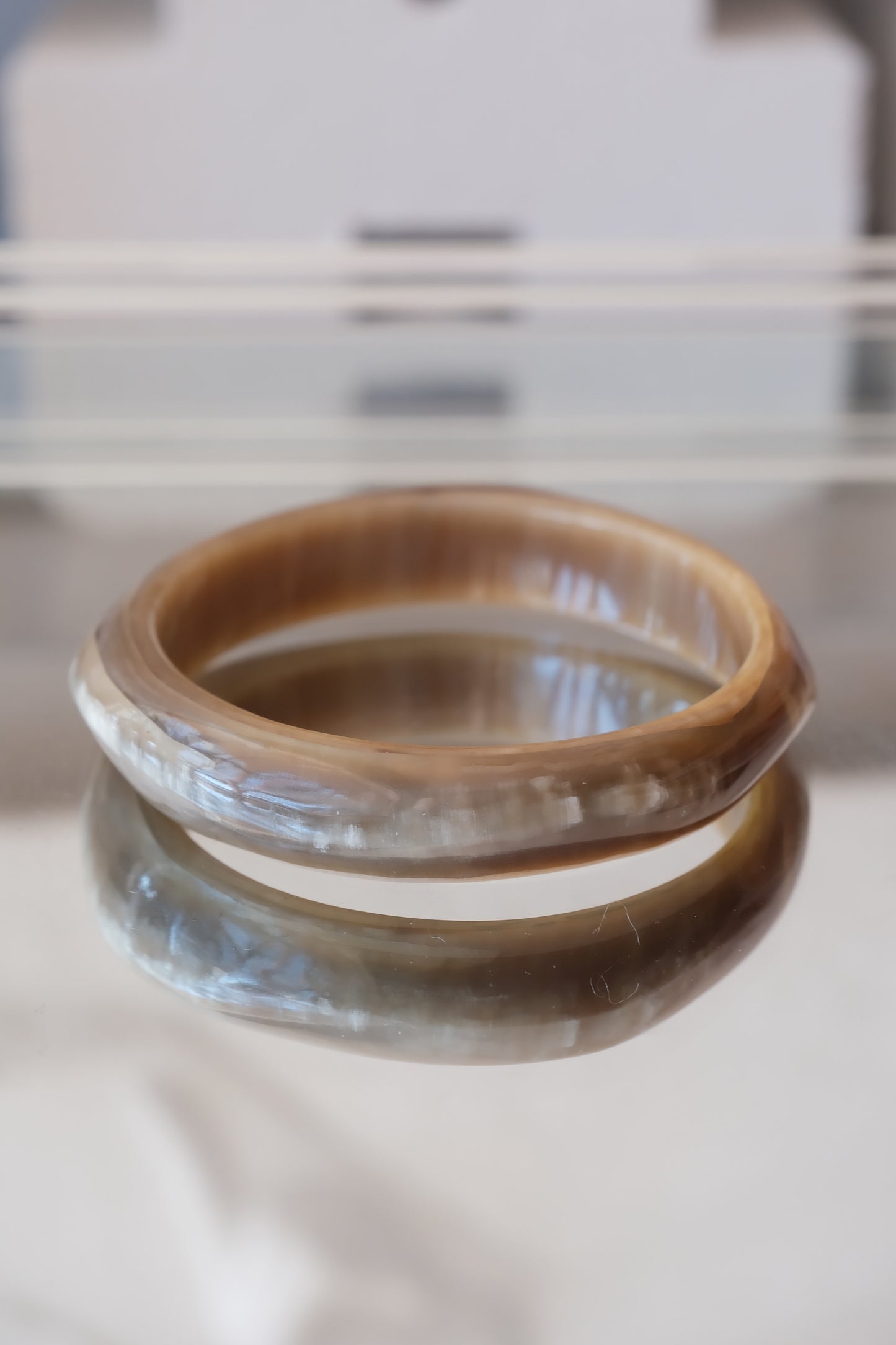 Natural horn bangle — styled on glass surface