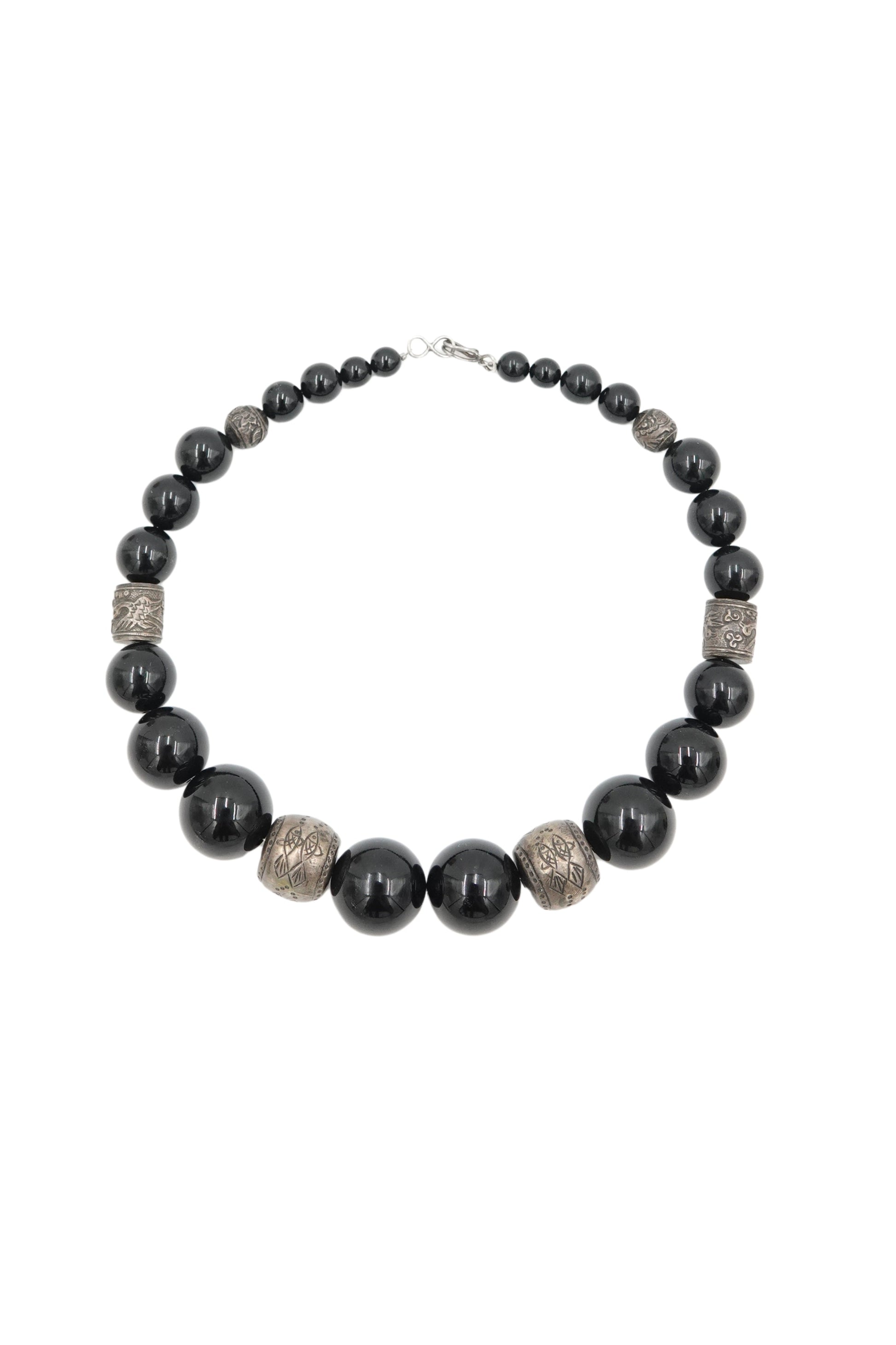 Vintage 1980s black onyx beaded necklace with engraved silver spacers — full length on white