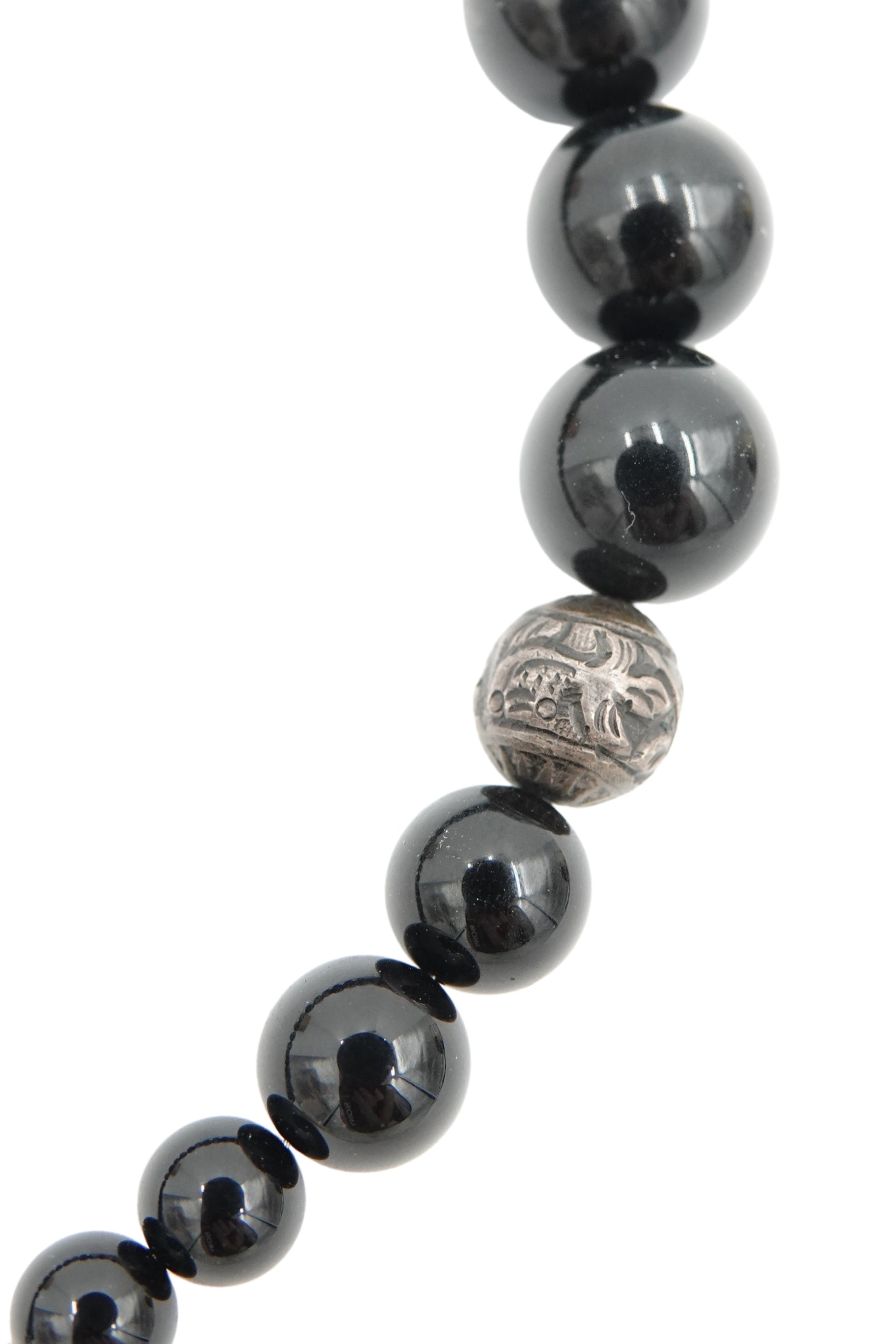 Vintage 1980s black onyx beaded necklace — detail of figurative engraved motifs on silver spacers