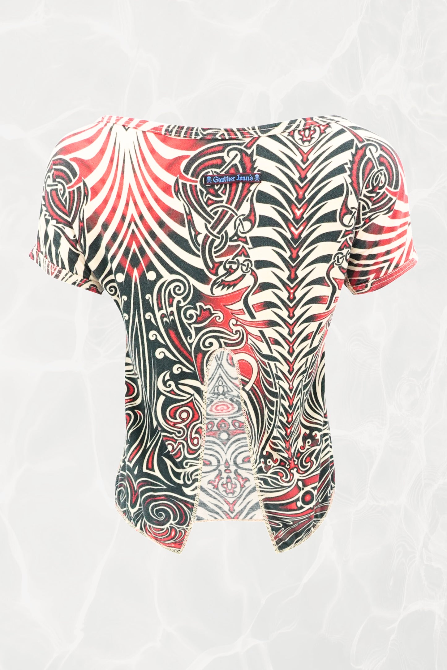 Jean Paul Gaultier JPG Jeans SS96 Cyberbaba crop top back view: open-back design showing J.P. Gaultier Jeans label, tribal tattoo print in red, black and white jersey