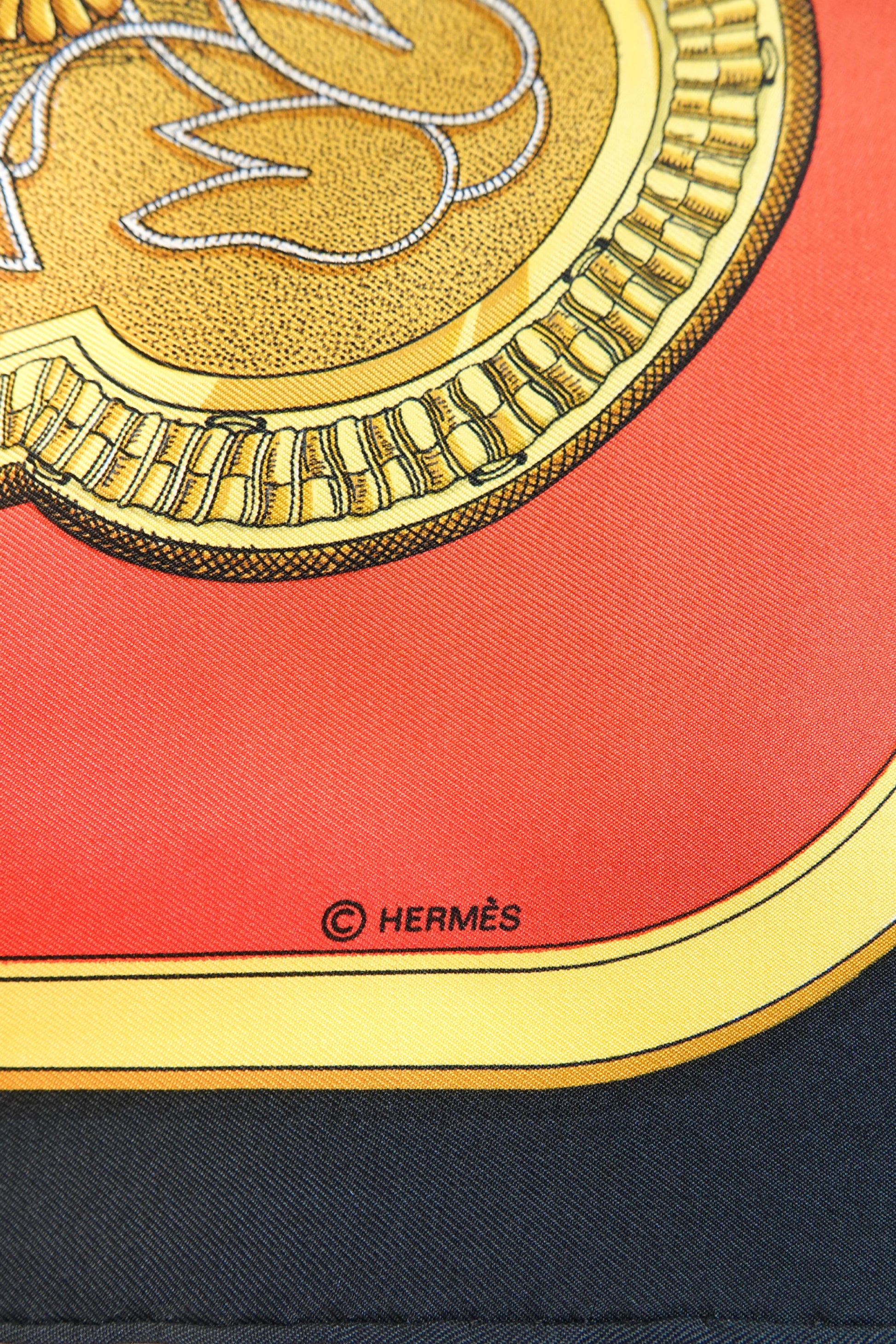 Hermès Grand Apparat Carré 90 gold medallion detail with © HERMÈS signature on red silk twill, archive condition
