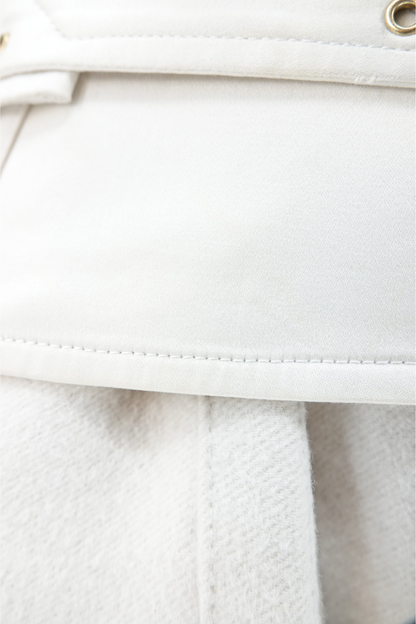 Tom Ford for Gucci AW03 white wool angora coat fabric detail: close-up of white wool angora texture with topstitched seam and gold brass stud eyelet on corset belt, Fall Winter 2003