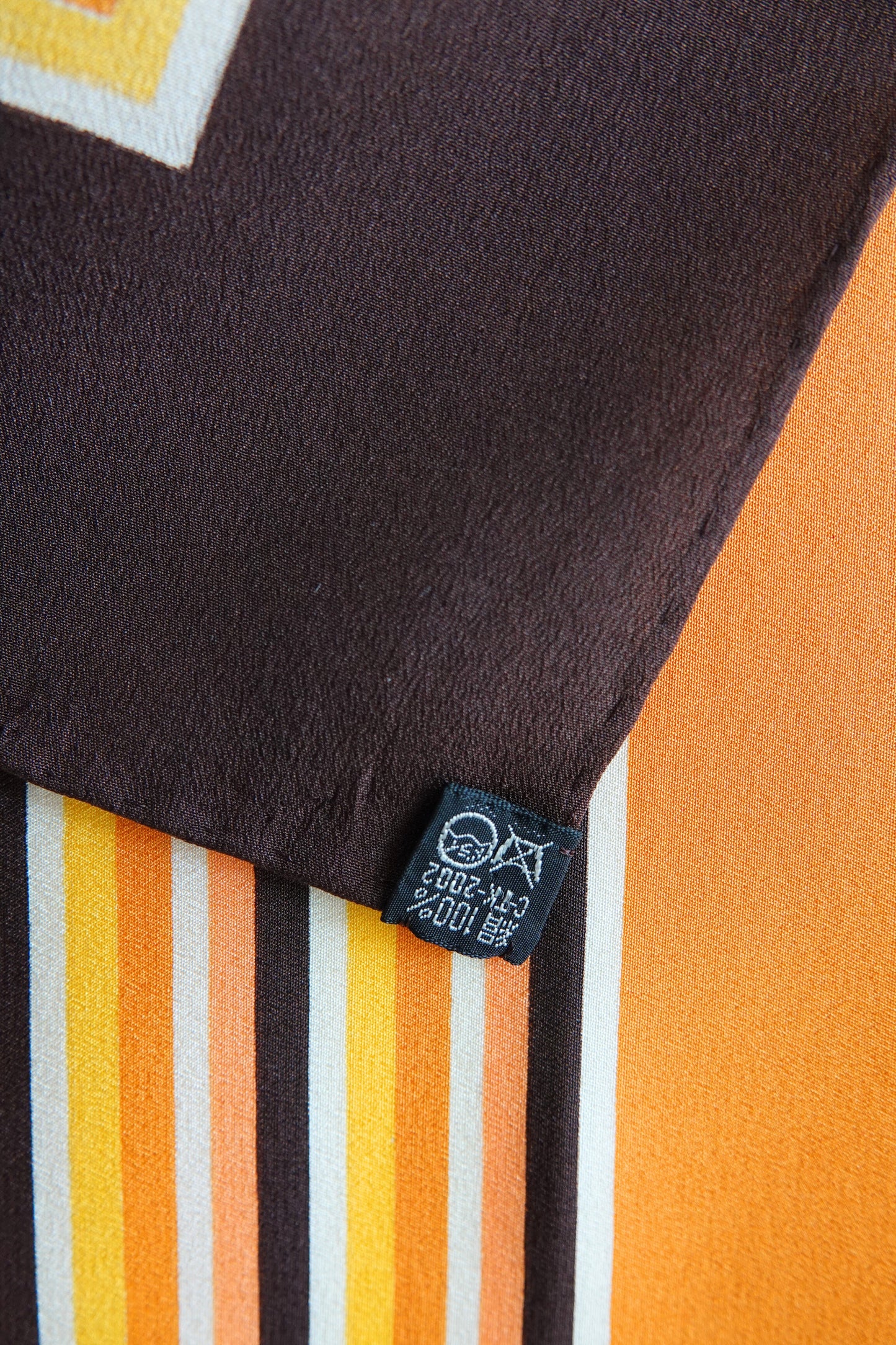1970s YSL Yves Saint Laurent silk scarf: folded view showing the scarf styled as a neckerchief highlighting how the square stripe print reads when worn