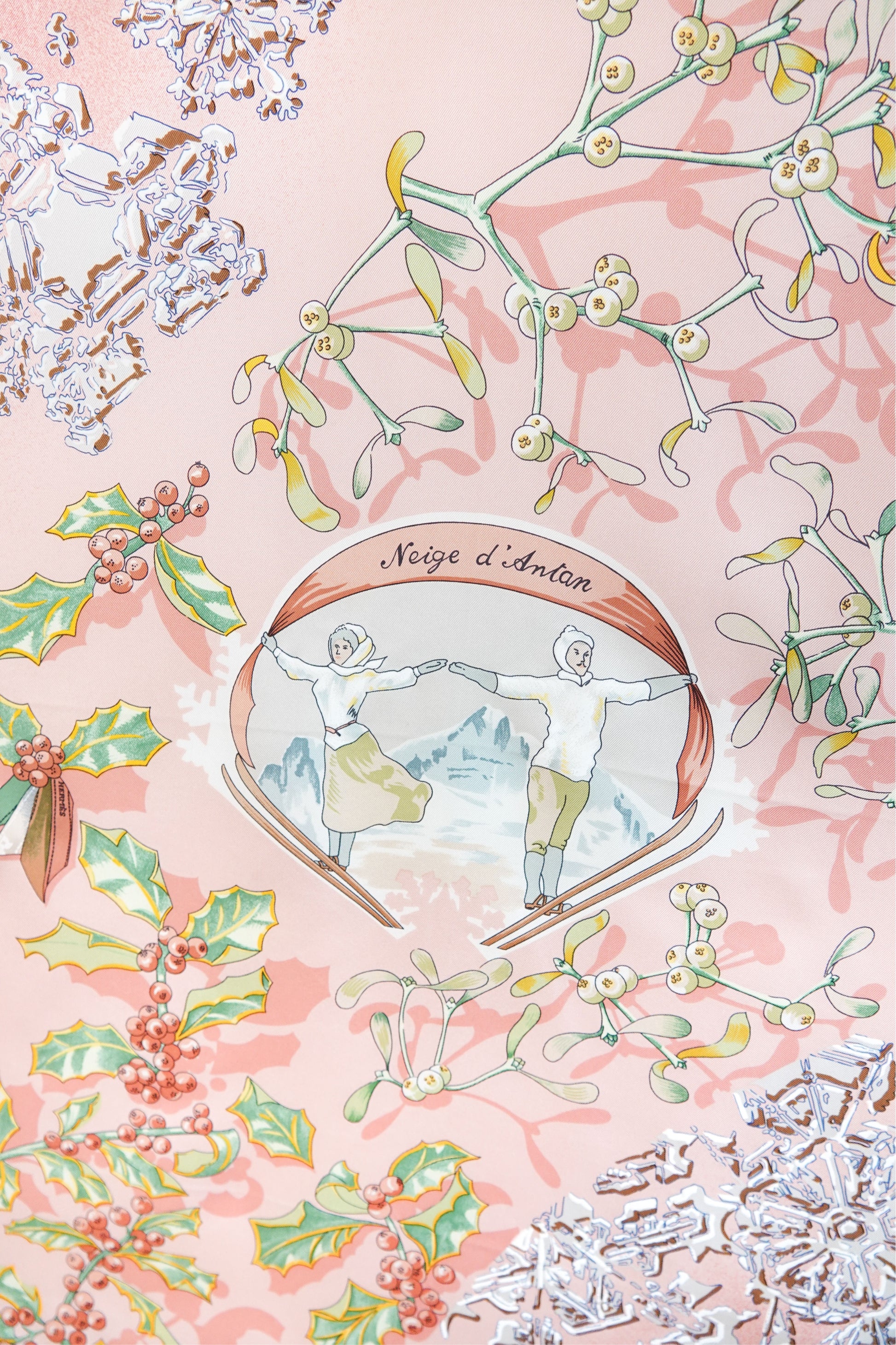 Hermès Neige d'Antan Carré 90 central medallion: "Neige d'Antan" cartouche with two ice skaters, mistletoe, holly and snowflake motifs on pink silk twill