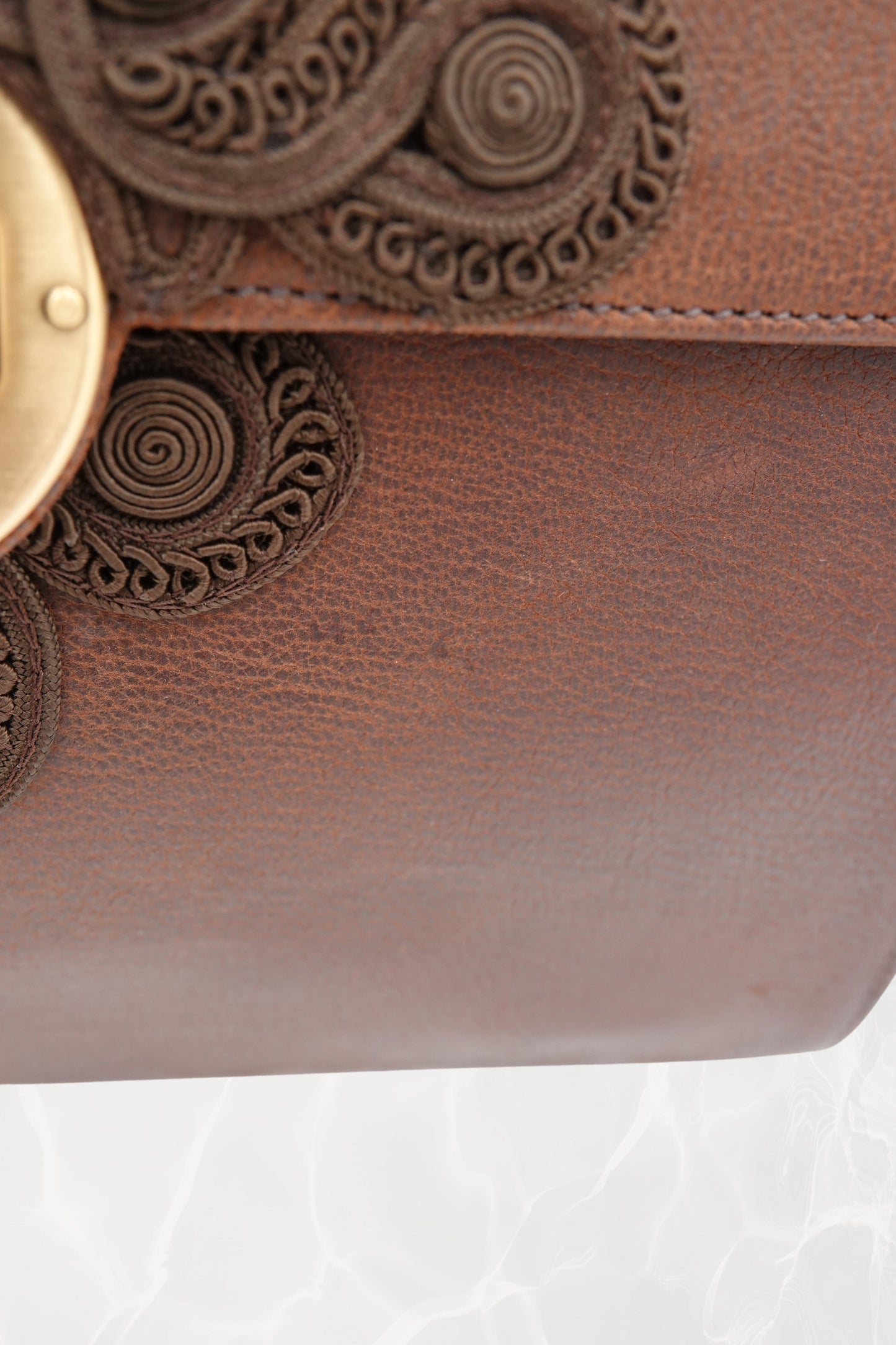 Close-up of passamane cord embroidery on vintage Prada Antic Passamane bag