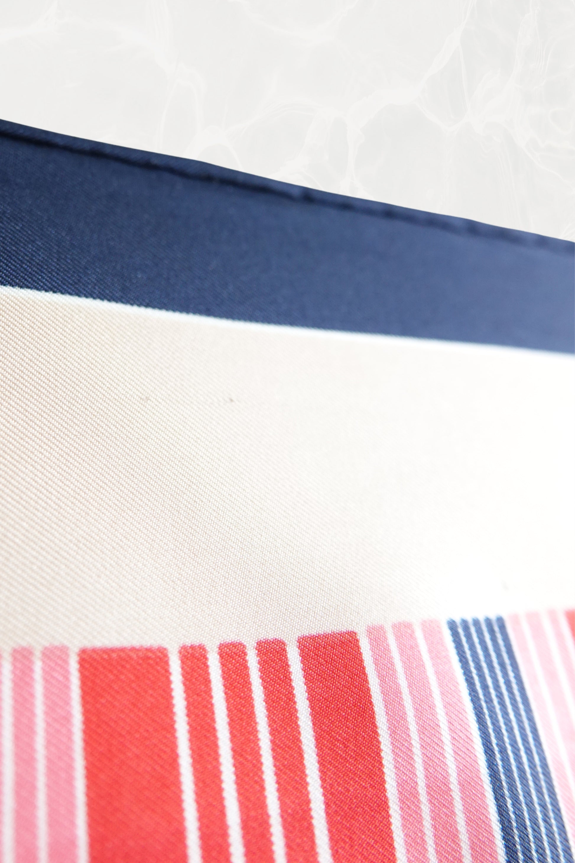 Late 1970s early 1980s YSL Yves Saint Laurent silk scarf: angled overhead view showing the full color palette and geometric stripe composition across the scarf
