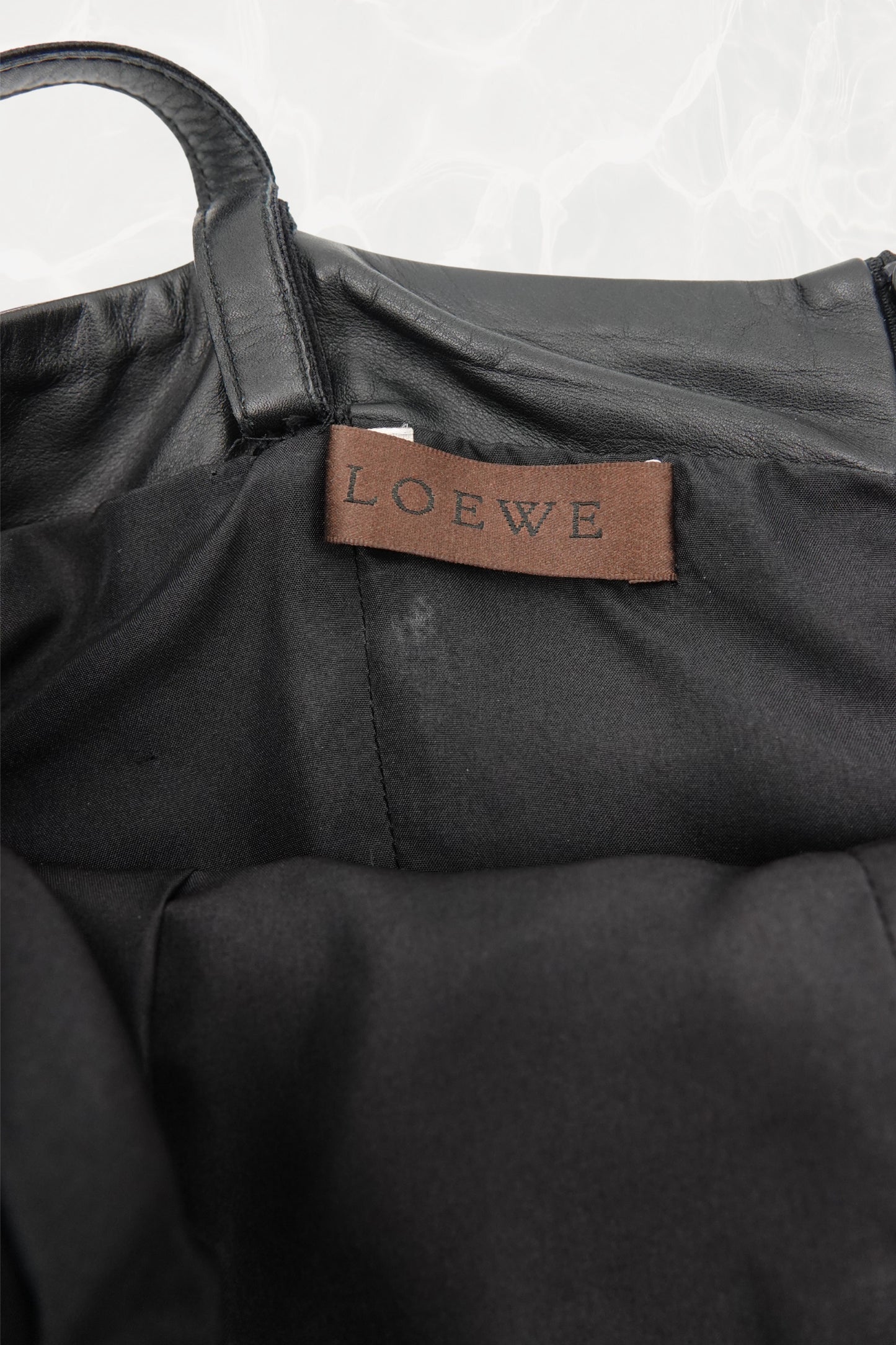 Loewe by Narciso Rodriguez AW01 studded leather dress silk skirt detail: close-up of paneled black silk twill flare skirt showing draped construction and contrast with the metal-studded leather bodice, AW2001