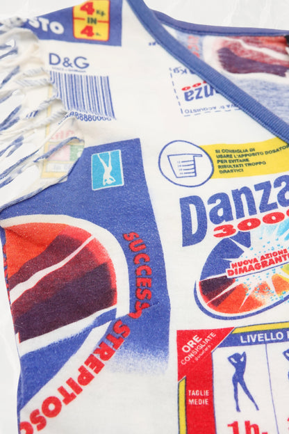 D&G SS02 Danza 3000 jersey top close-up: D&G label and Danza 3000 advertising graphic print detail with fringe trim visible, bold blue text and Italian advertising imagery