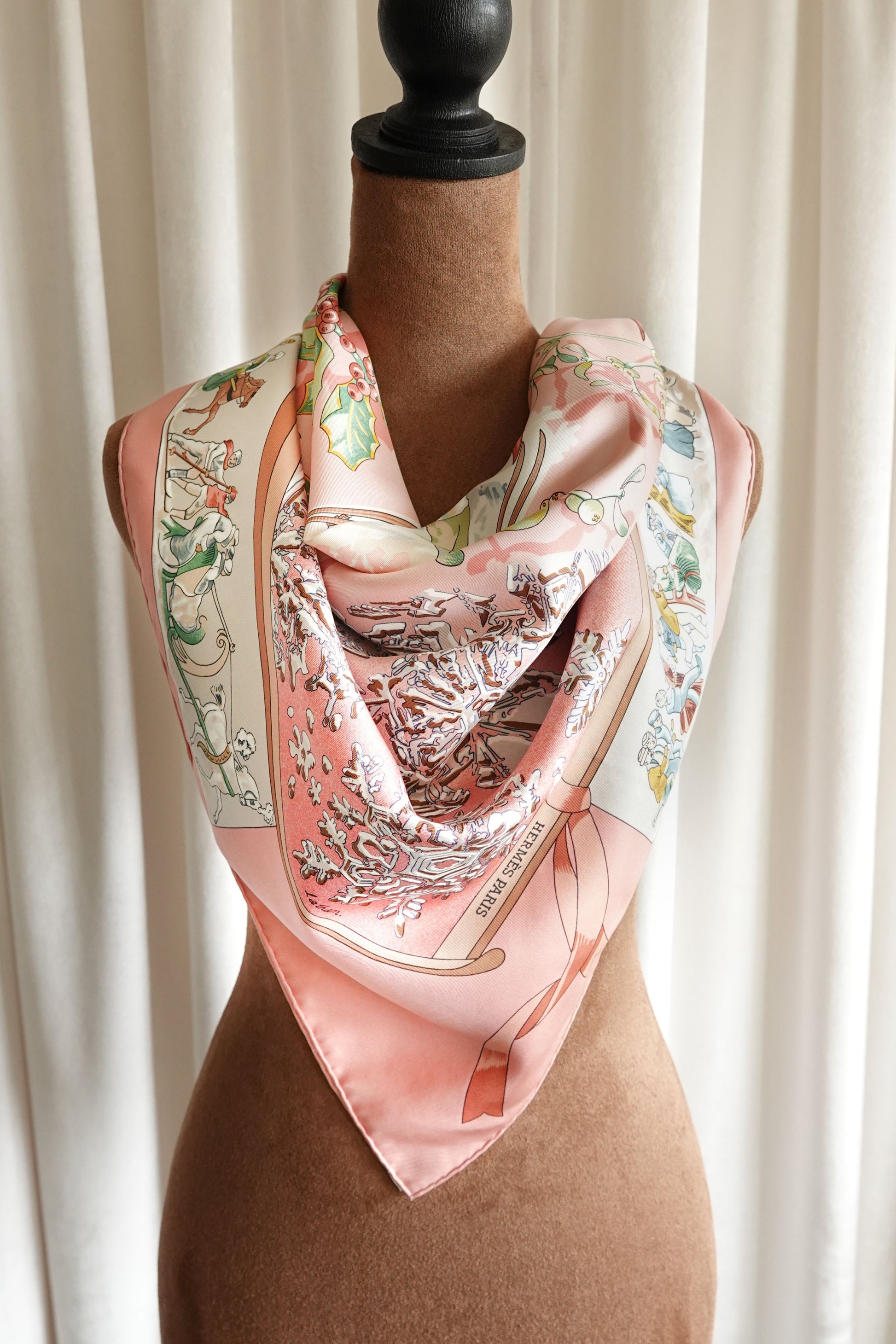 Hermès Neige d'Antan Carré 90 silk scarf styled on mannequin, pink ground with winter botanical motif